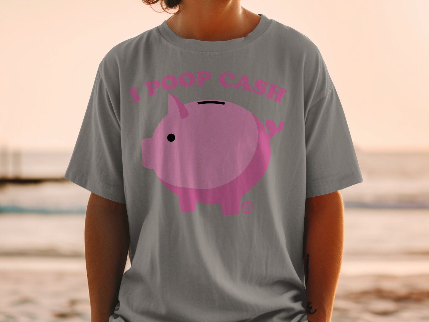 Grey t-shirt with pink piggy bank graphic and "I POOP CASH" text.