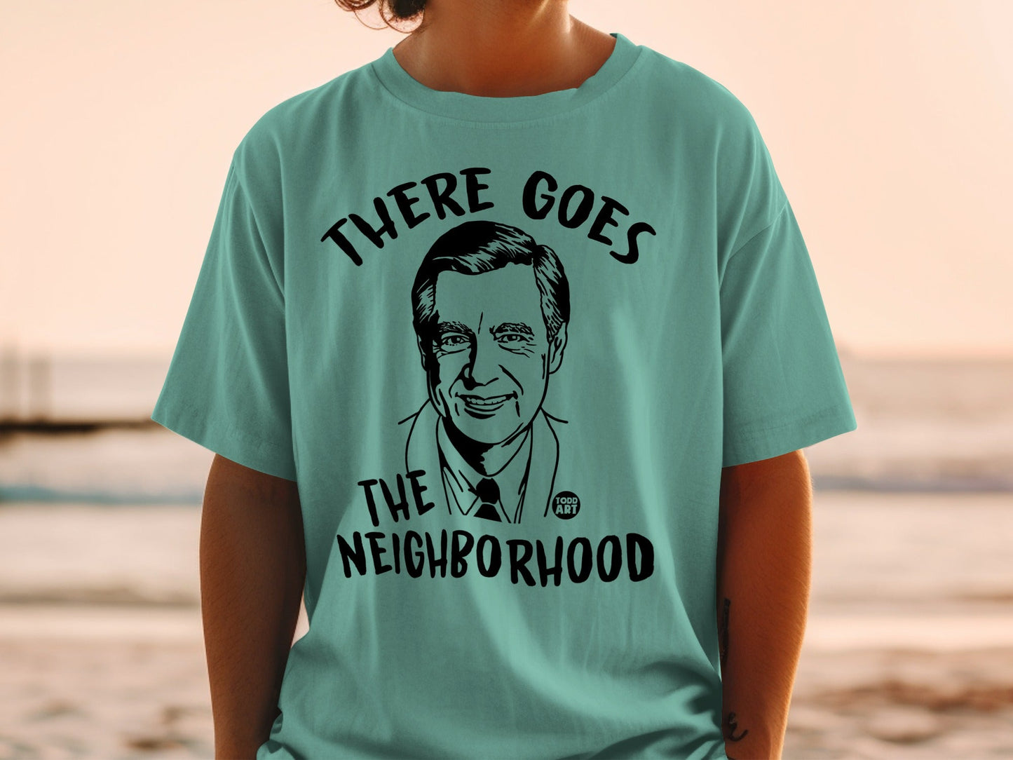 T-shirt with graphic of Fred Rogers saying "There Goes the Neighborhood".