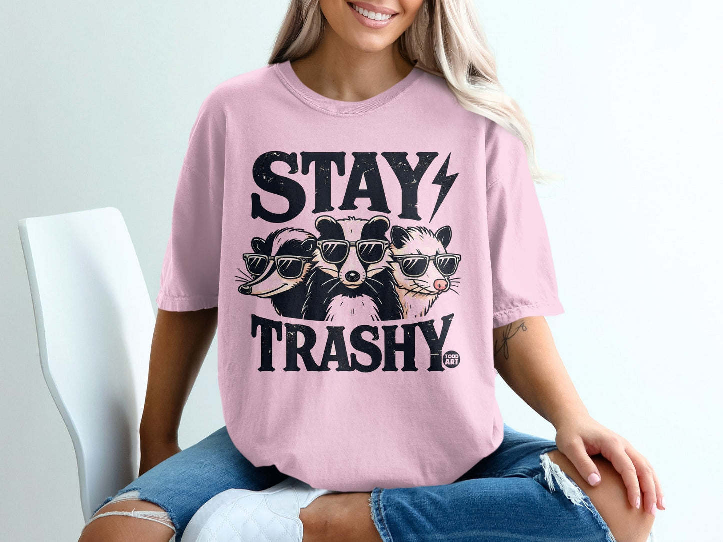 T-shirt with three badgers wearing sunglasses and the text "STAY TRASHY."
