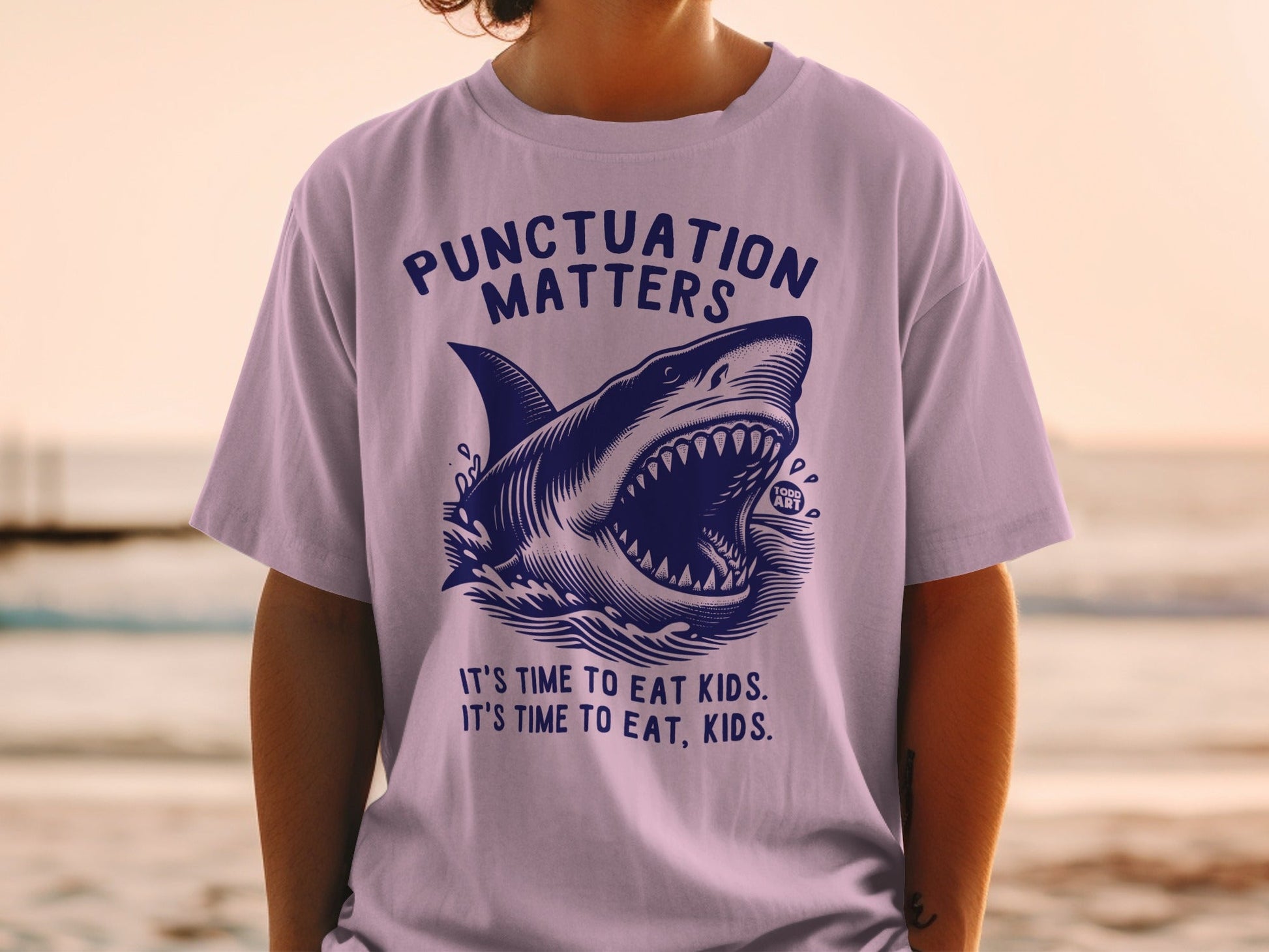 Purple t-shirt with shark graphic and text "Punctuation Matters".