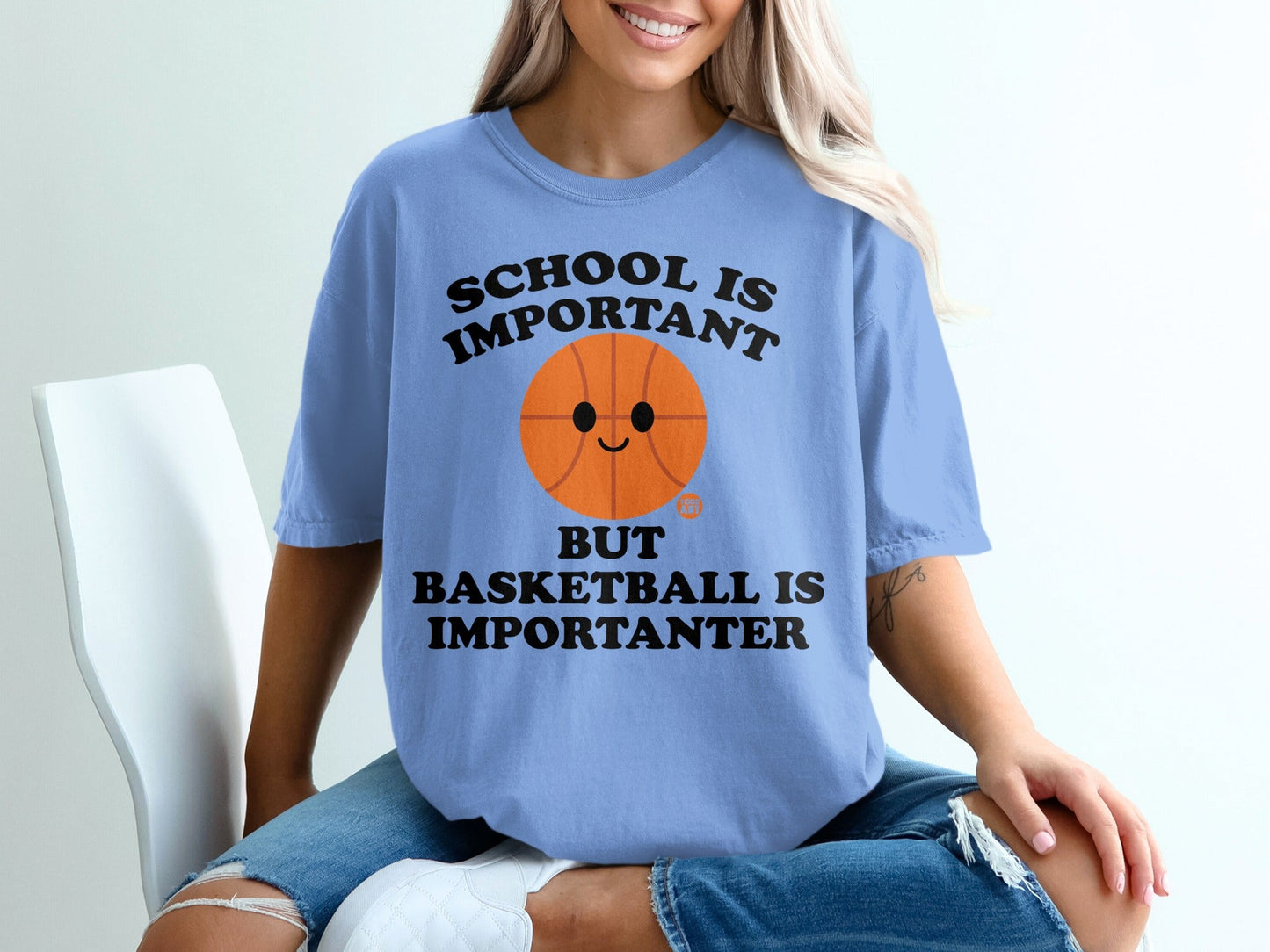 Light blue t-shirt with basketball graphic and text.