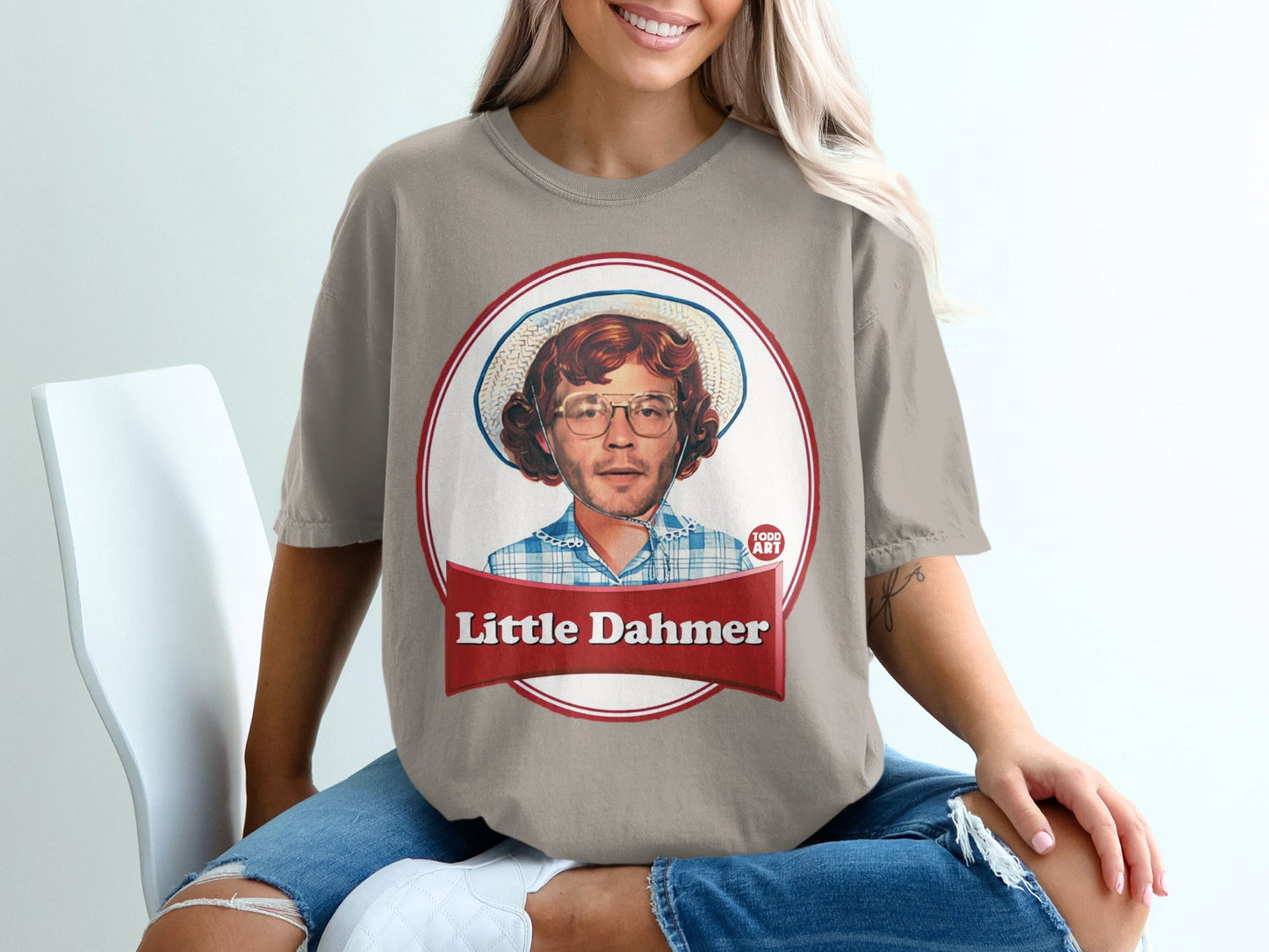 T-shirt with portrait of a young man wearing glasses and a straw hat.