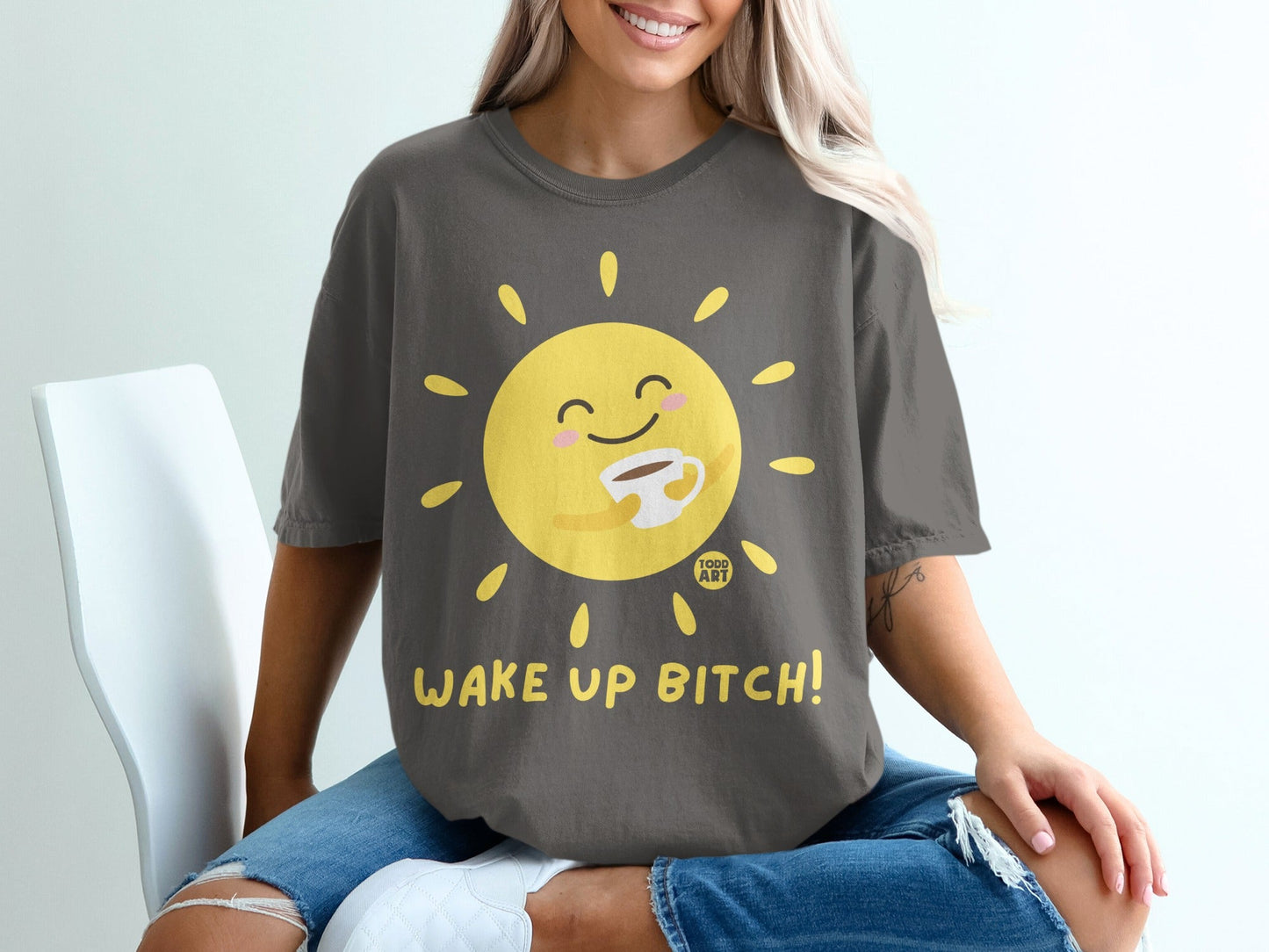 T-shirt with smiling sun holding coffee cup, "WAKE UP BITCH!" text.