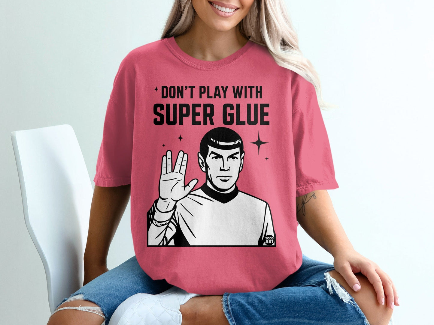 Spock from Star Trek on a pink t-shirt saying "Don't play with super glue".