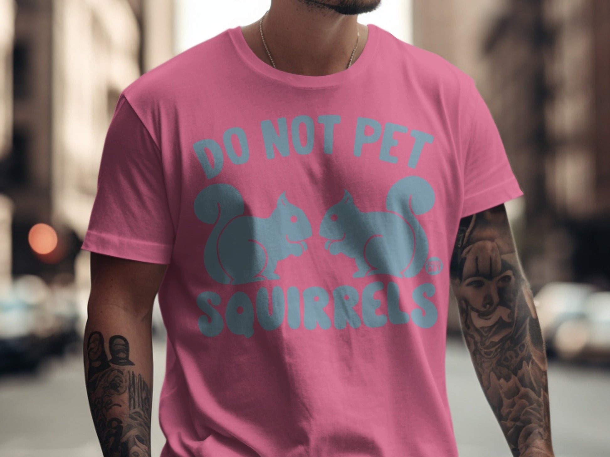 Pink t-shirt with light blue "DO NOT PET SQUIRRELS" text and two squirrel graphics.