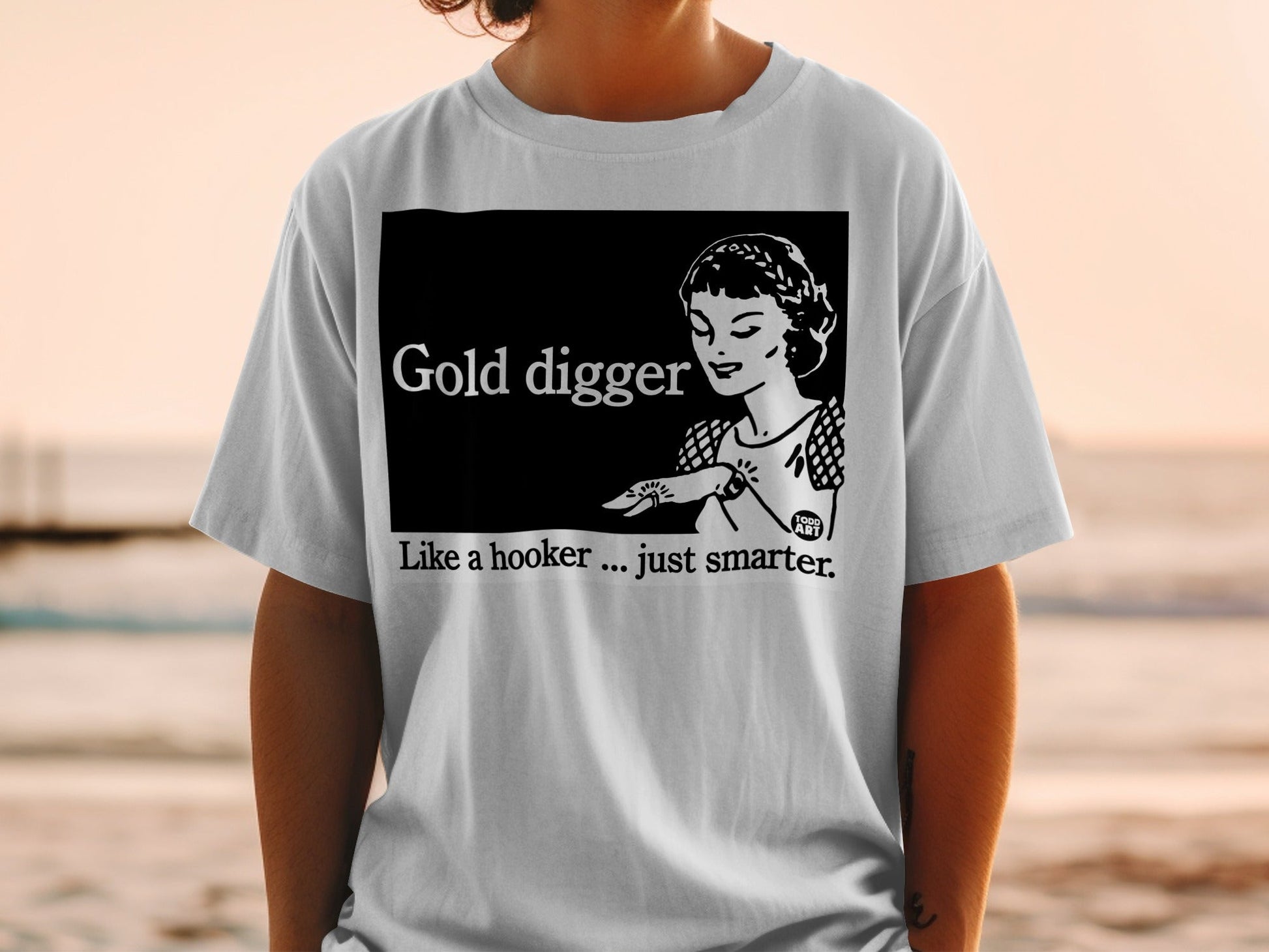 White t-shirt with "Gold digger" and woman illustration.