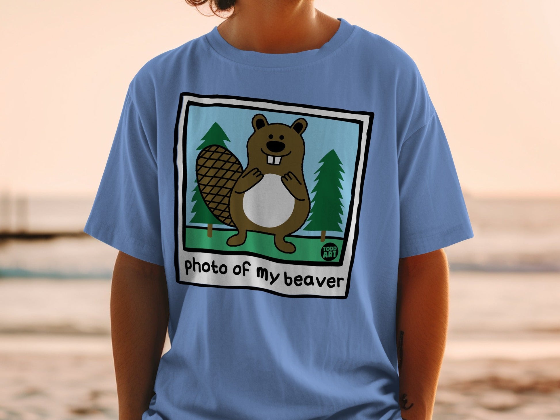T-shirt with cartoon beaver in a forest, text "photo of my beaver".