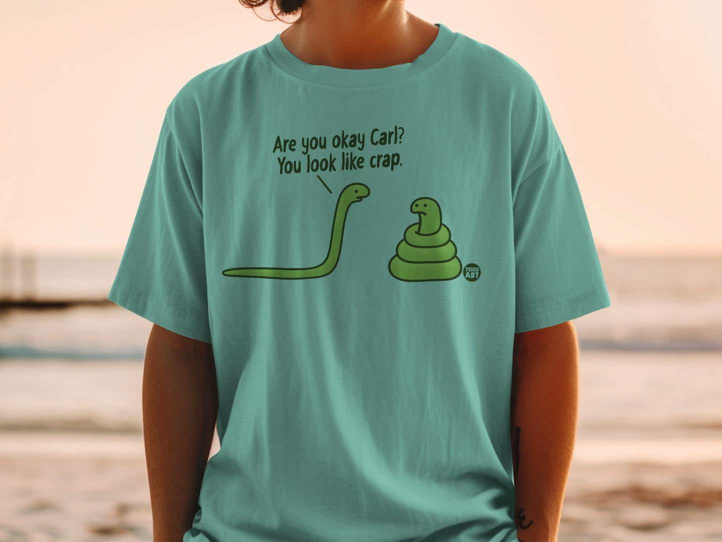 Green t-shirt with cartoon snakes, one asking "Are you okay Carl? You look like crap."