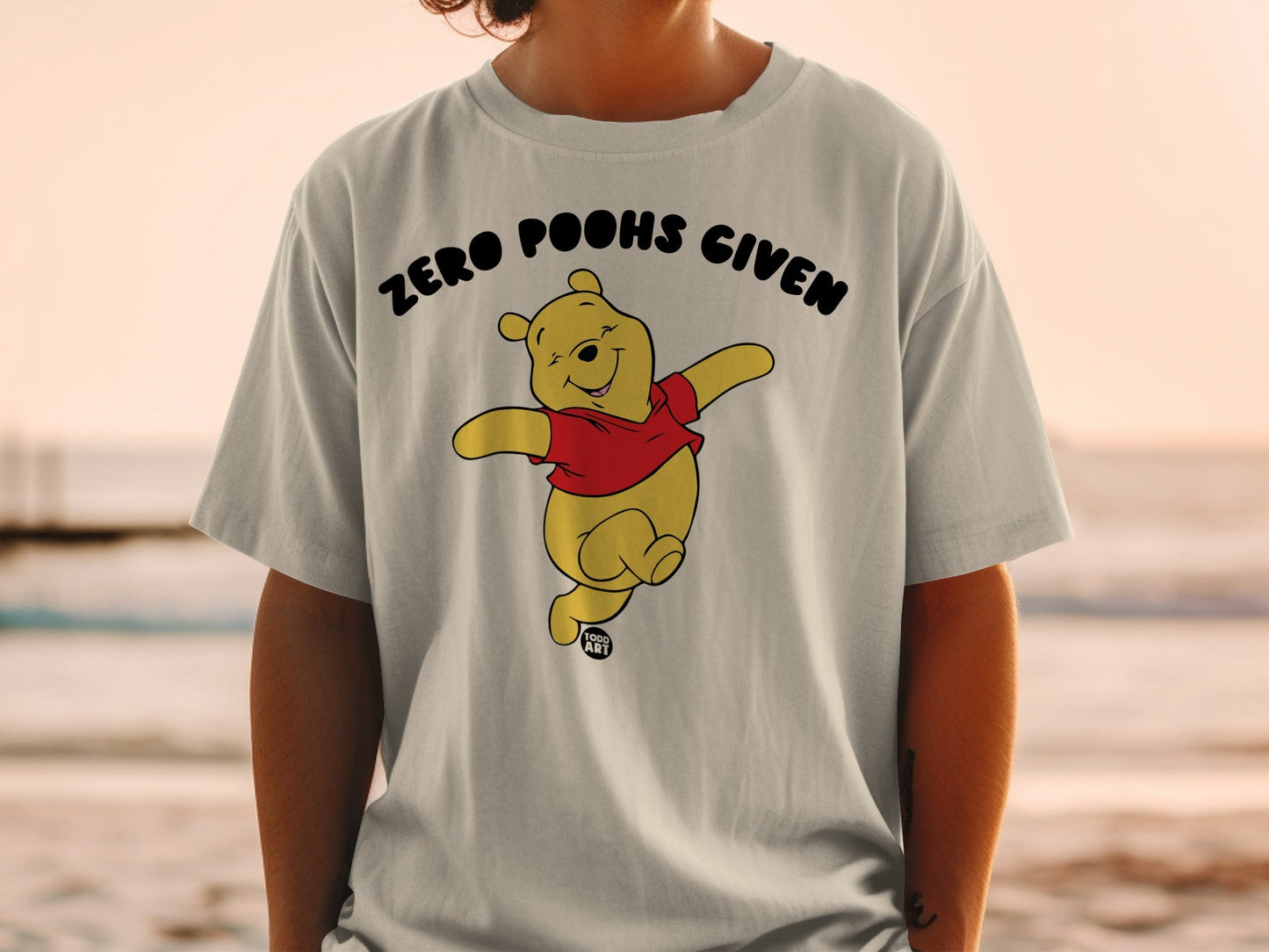 Winnie the Pooh graphic t-shirt with "Zero Poohs Given" text.