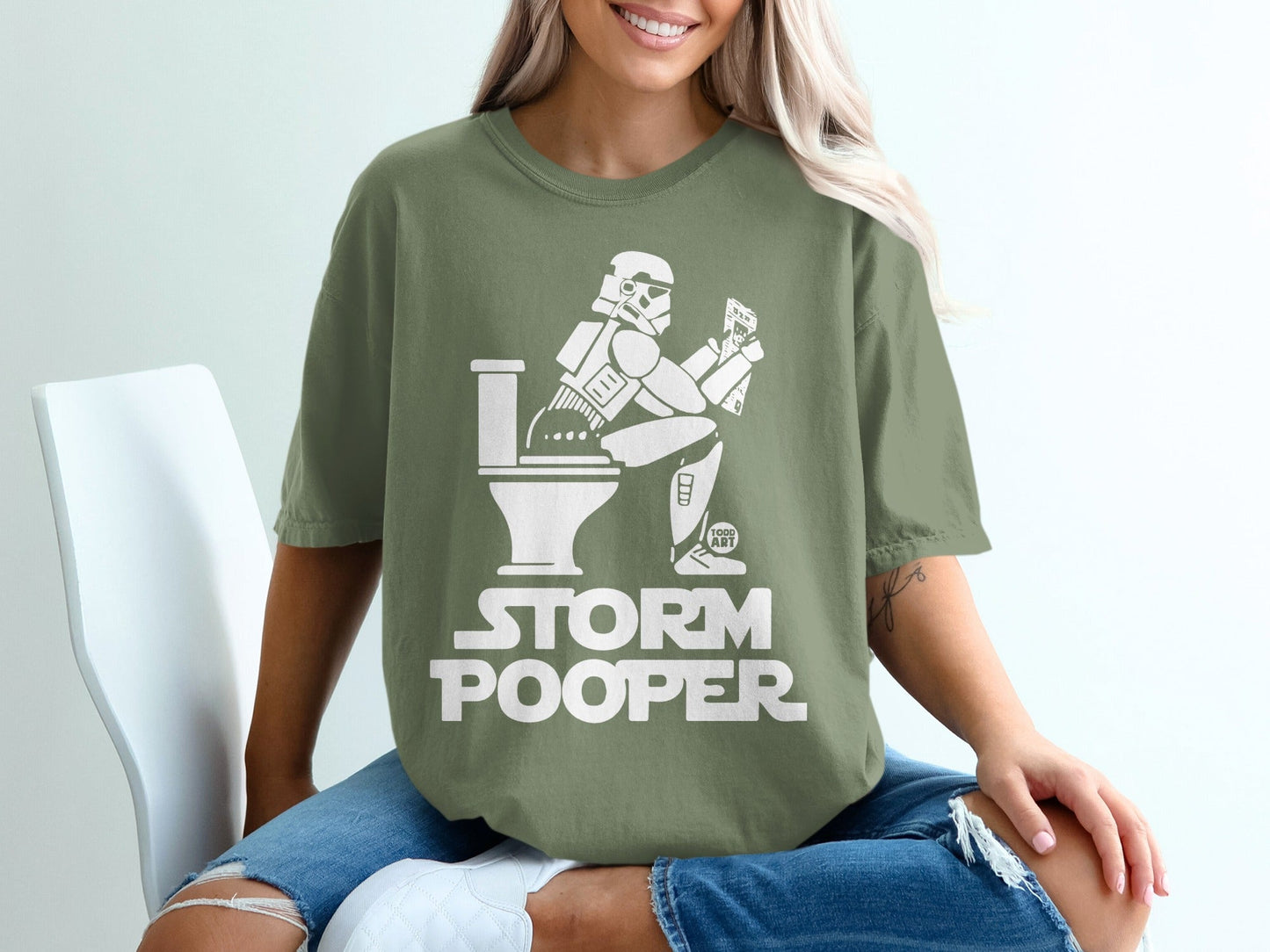 Stormtrooper sitting on a toilet with "Storm Pooper" text.