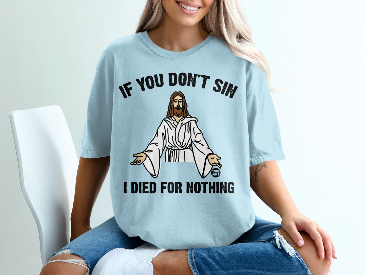 Light blue t-shirt with "IF YOU DON'T SIN I DIED FOR NOTHING" and Jesus graphic.