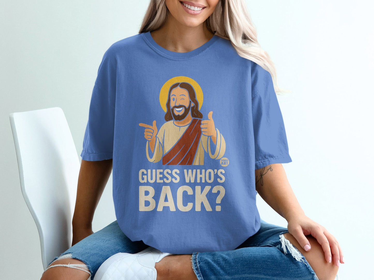 Blue t-shirt with Jesus graphic and text "GUESS WHO'S BACK?"