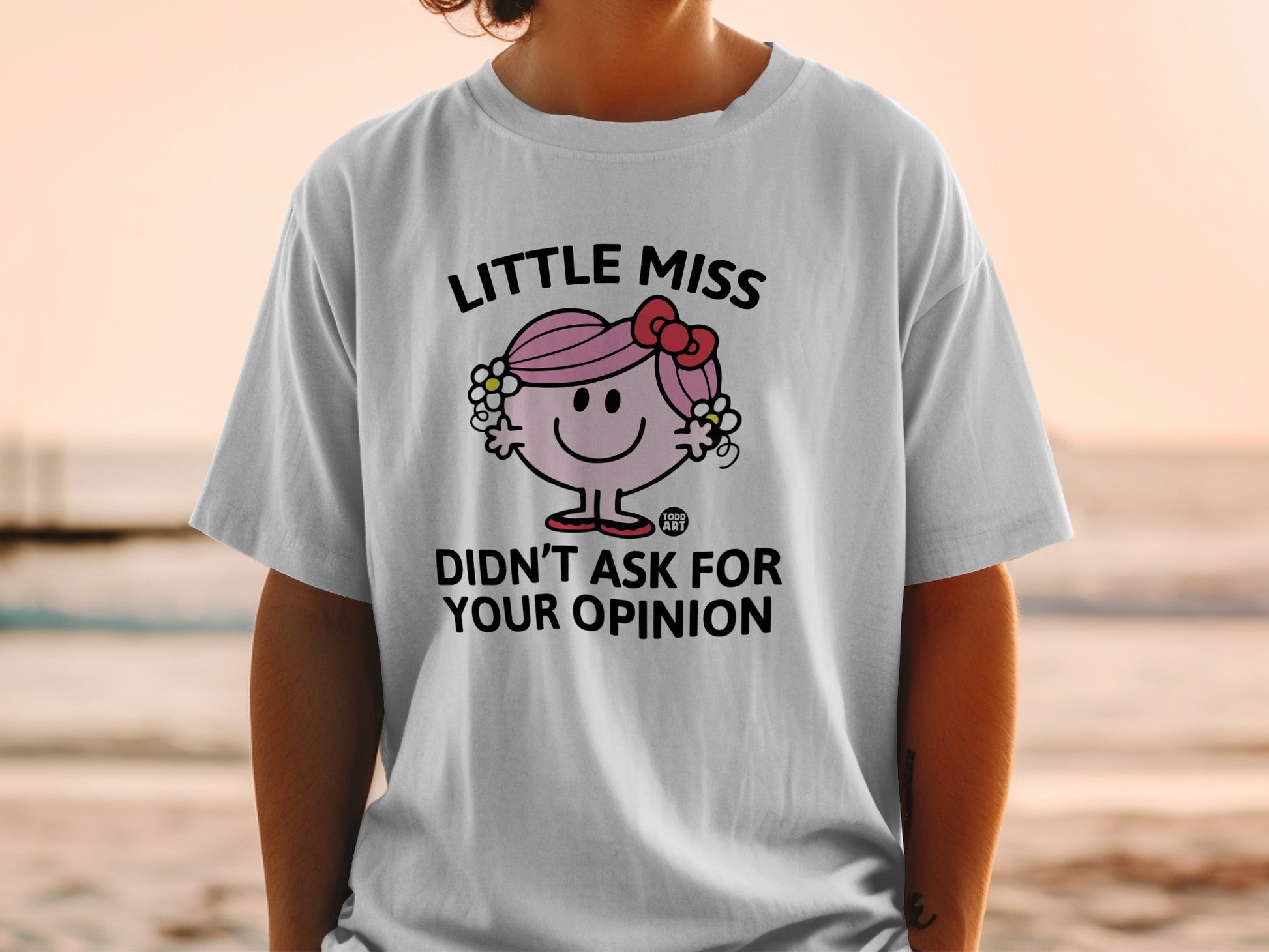 White t-shirt with Little Miss characters and the text "DIDN'T ASK FOR YOUR OPINION".