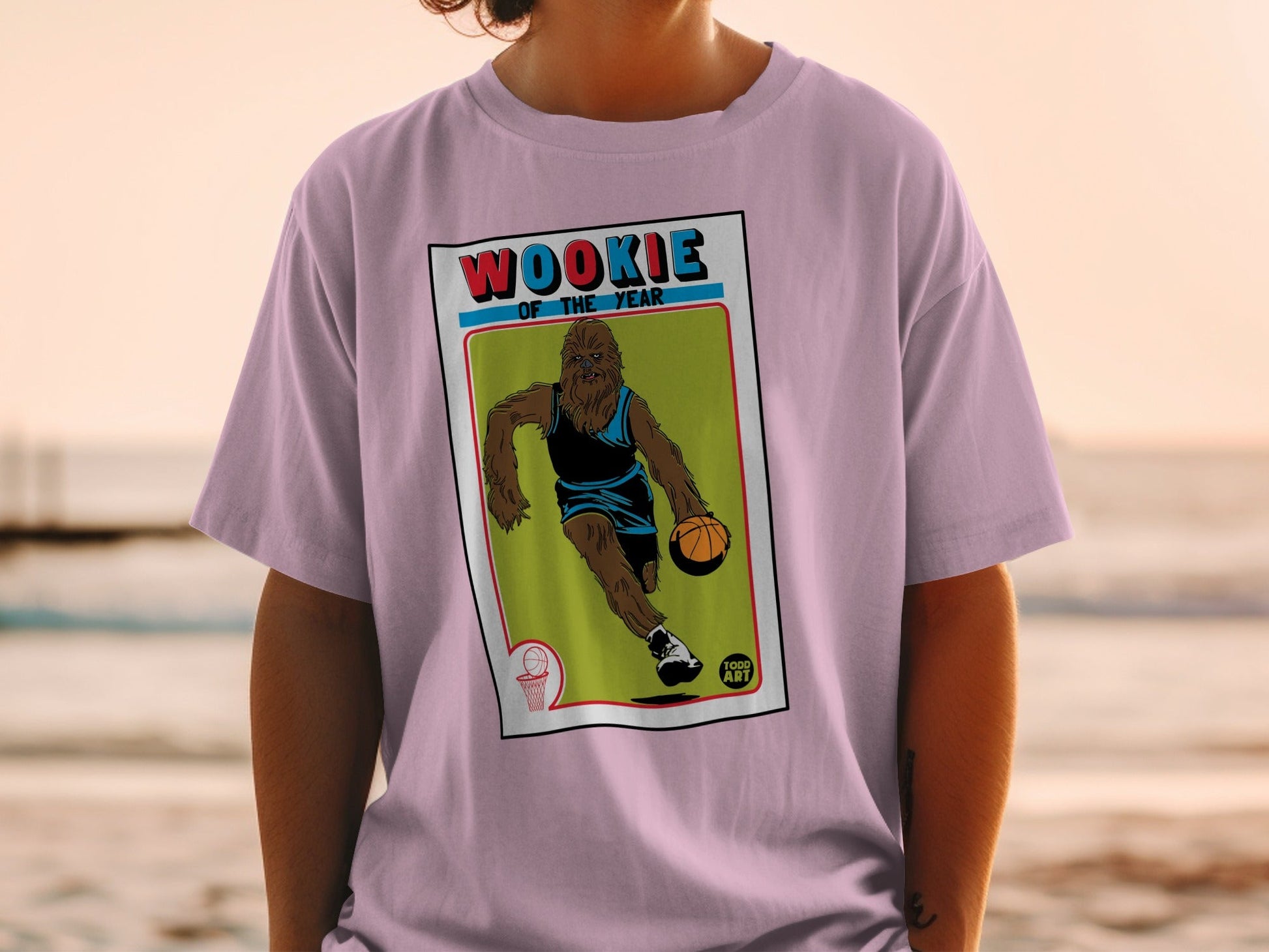 Basketball player graphic on a purple t-shirt with "WOOKIE OF THE YEAR" text.
