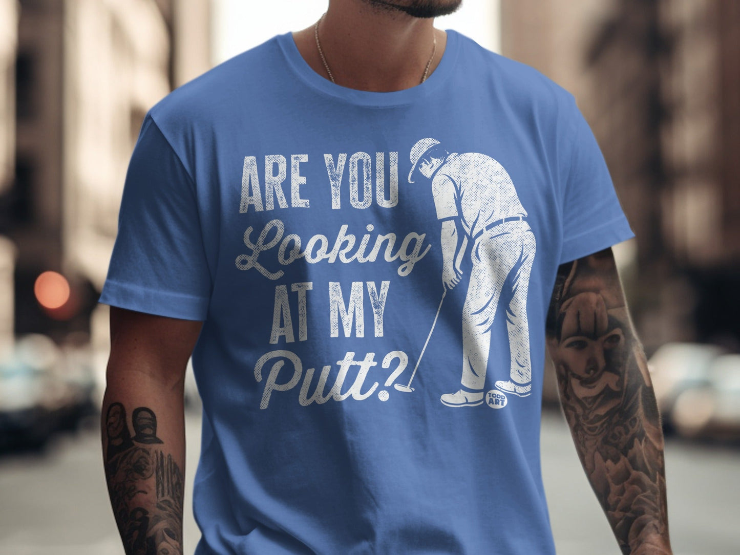 Blue t-shirt with "Are You Looking At My Putt?" and golf graphic.