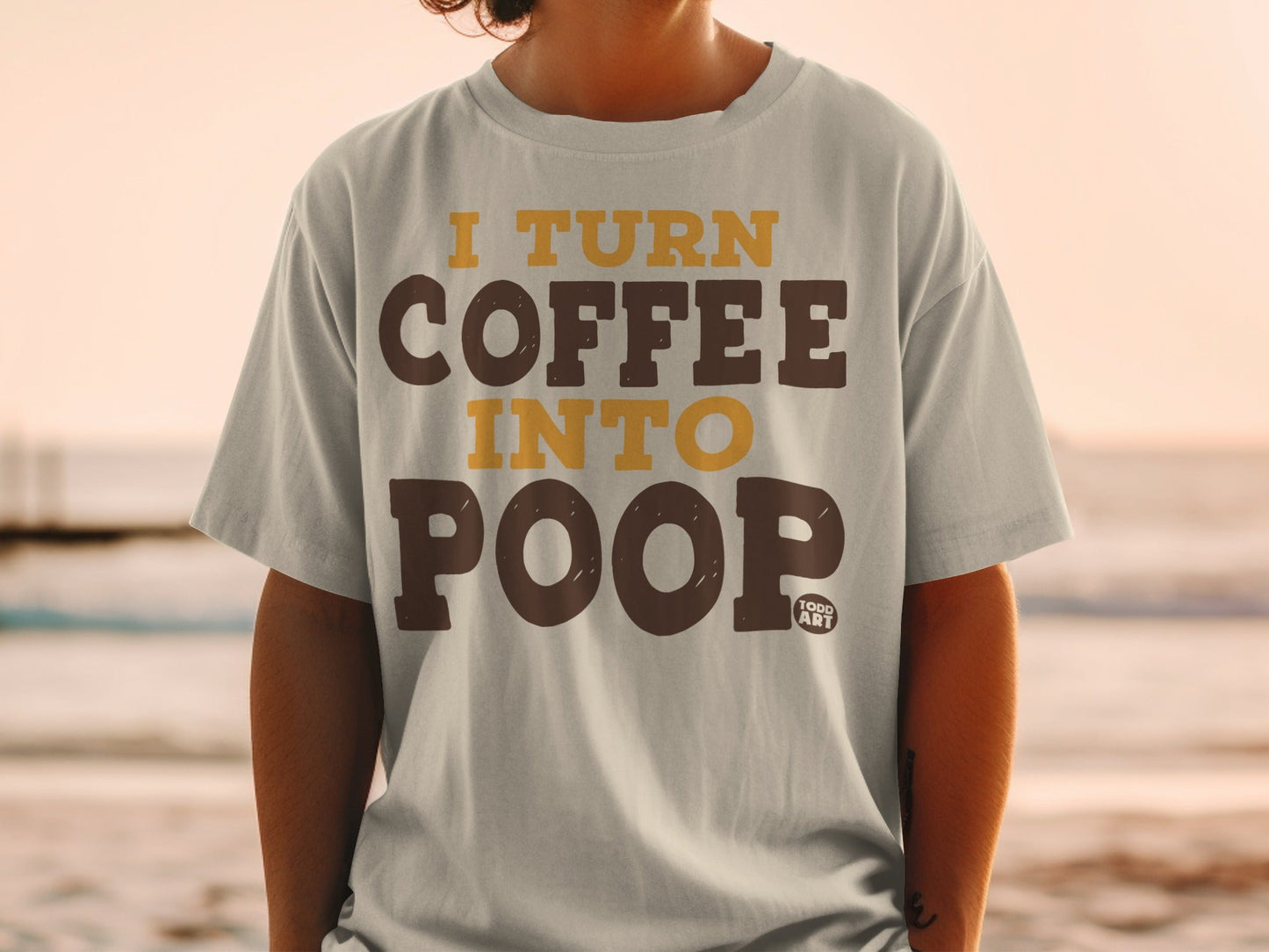 Light grey t-shirt with "I TURN COFFEE INTO POOP" text in brown and yellow.