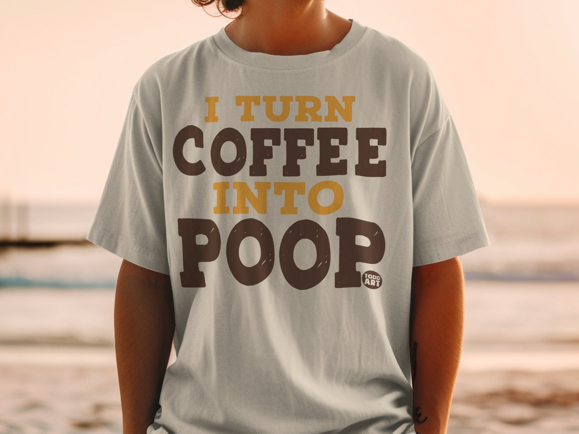 Light grey t-shirt with "I TURN COFFEE INTO POOP" text in brown and yellow.