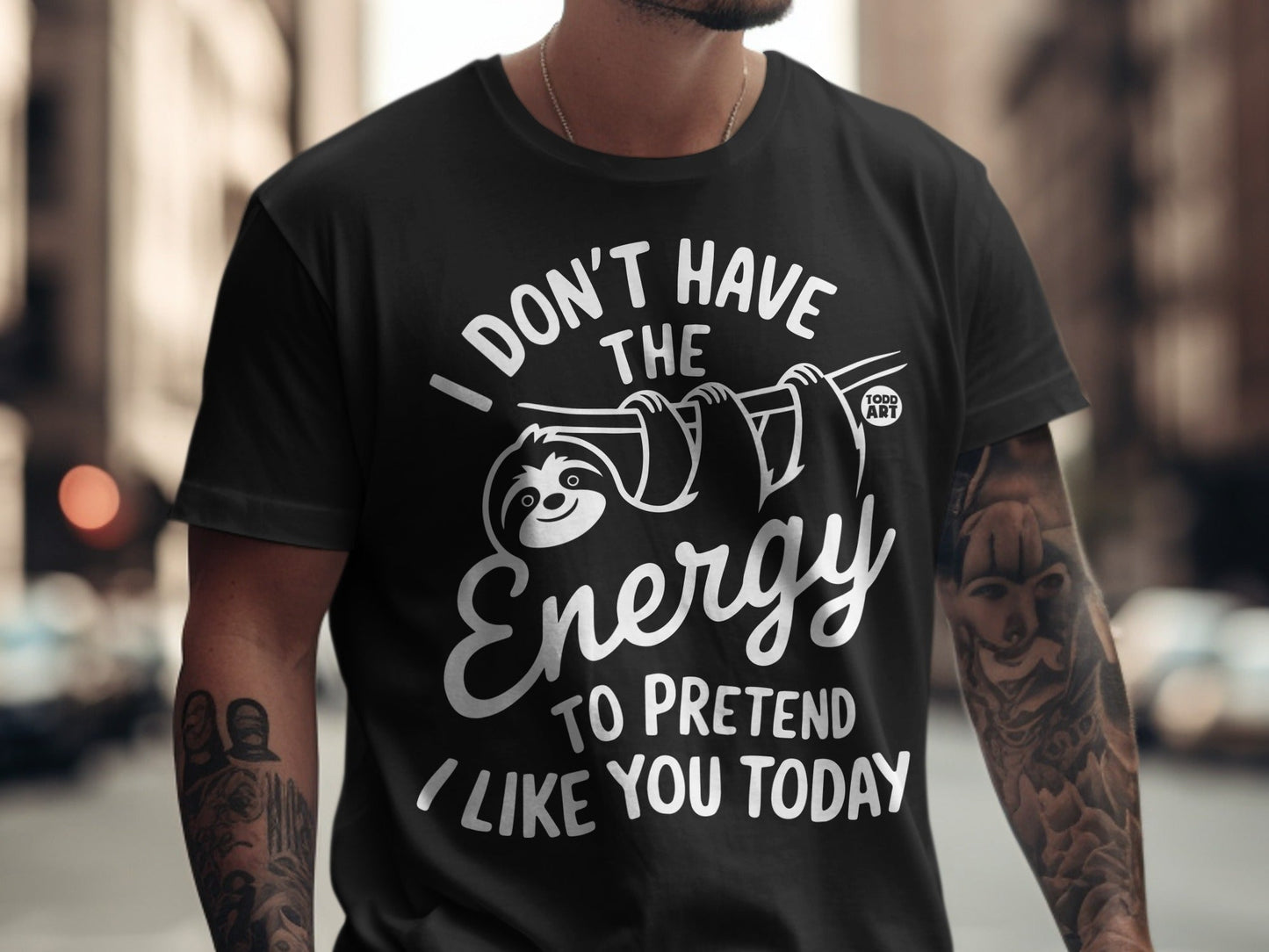 Black t-shirt with a sloth graphic and the text "I DON'T HAVE THE ENERGY TO PRETEND I LIKE YOU TODAY".