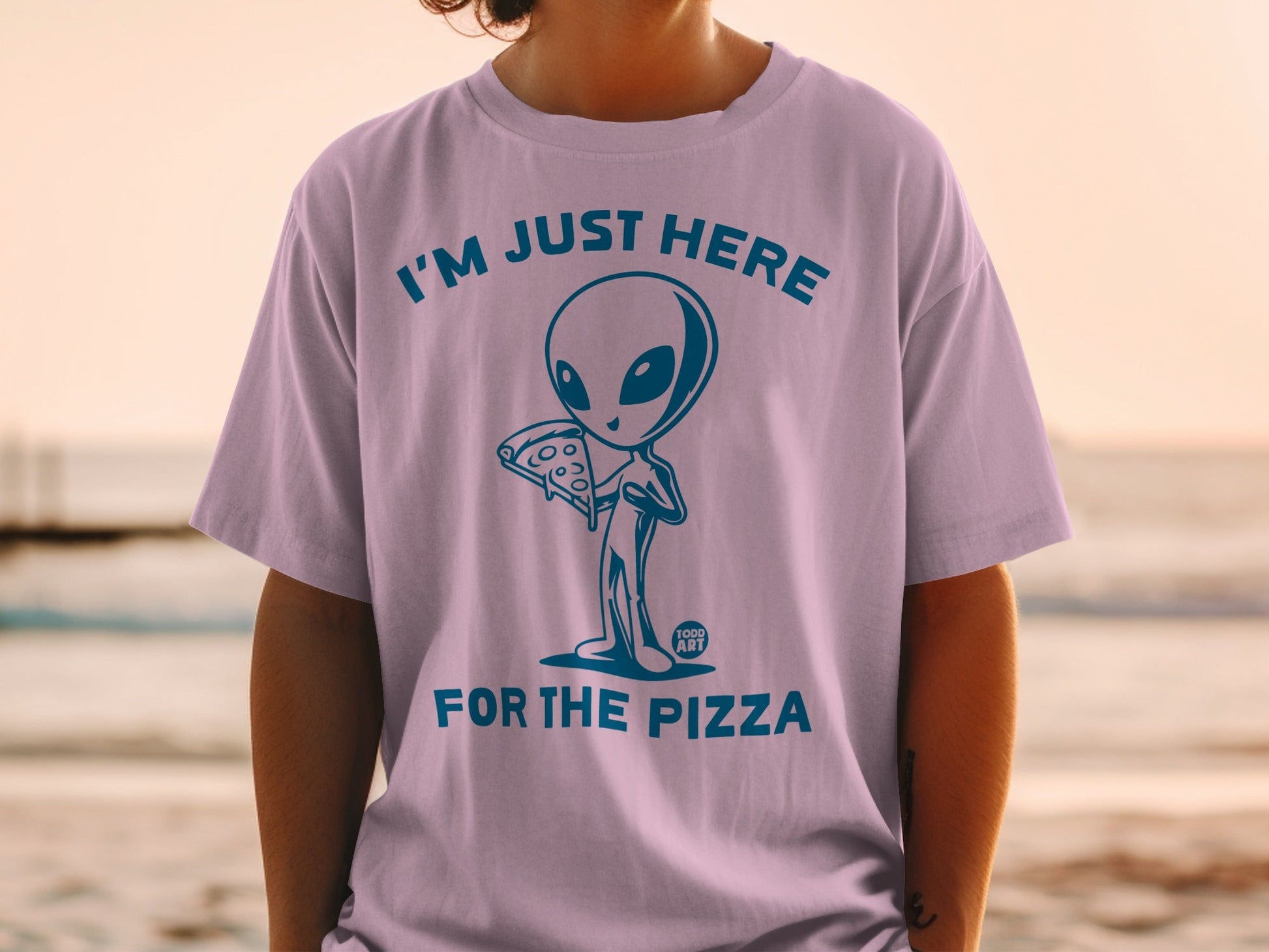 T-shirt with blue alien holding pizza, text reads "I'M JUST HERE FOR THE PIZZA".