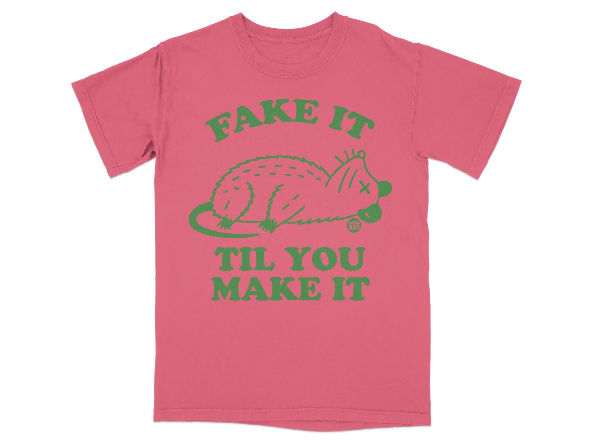 Pink t-shirt with green cartoon possum and text "Fake It Til You Make It".