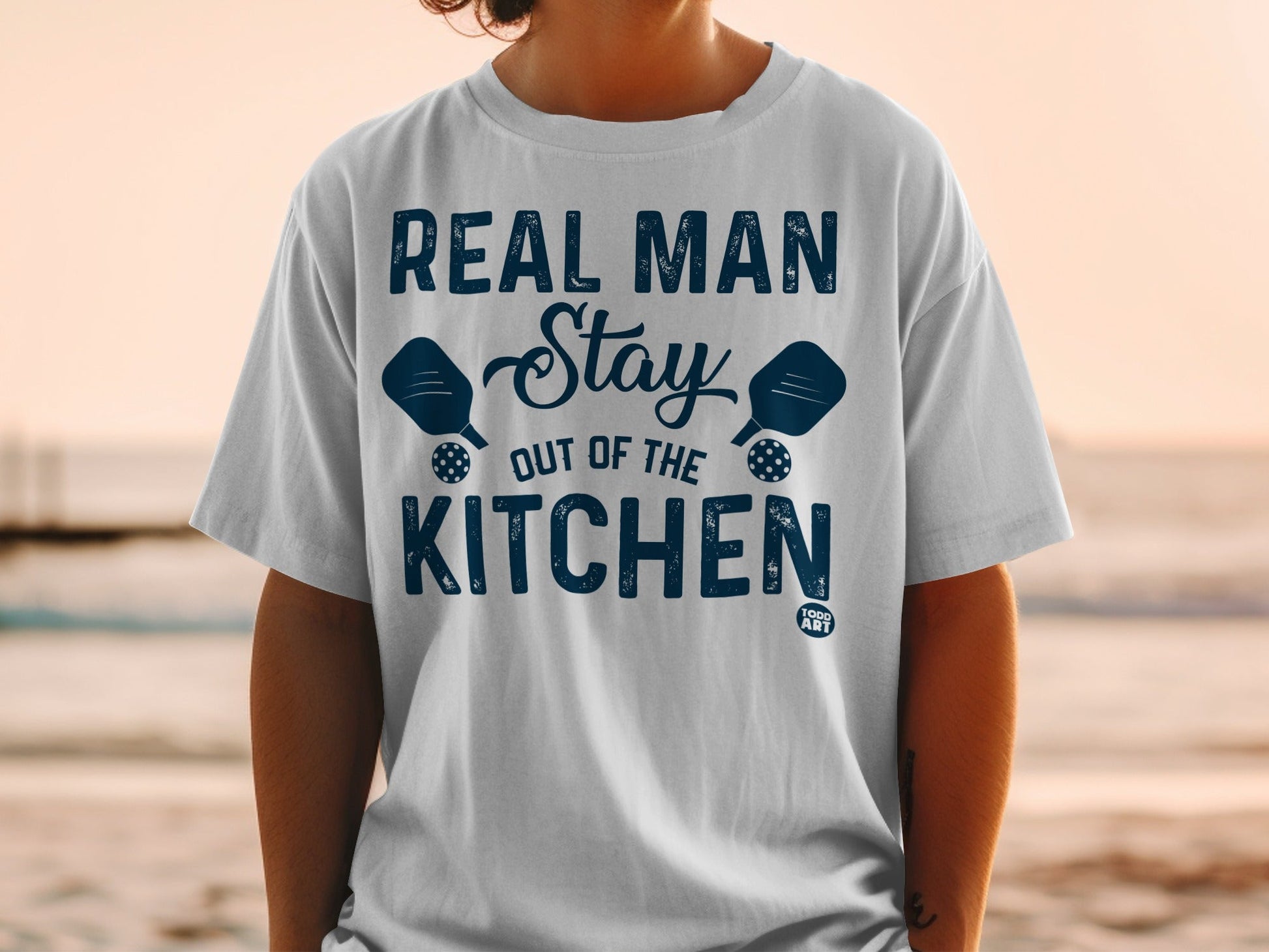 Real Man Stay Out Of The Kitchen pickleball graphic t-shirt.