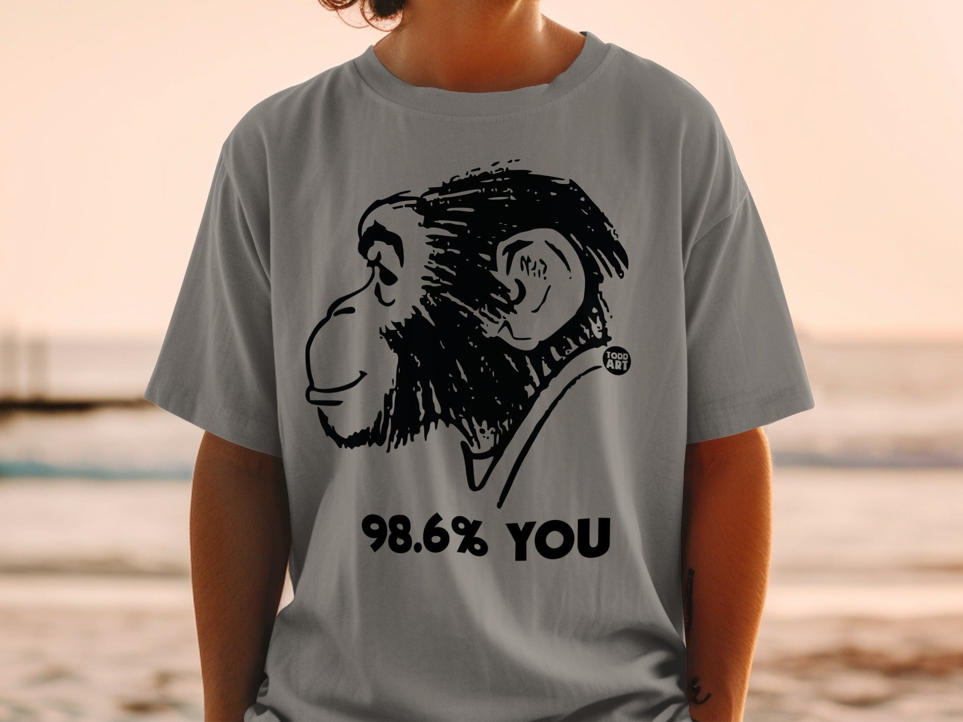 Grey t-shirt with black monkey illustration and "98.6% YOU" text.
