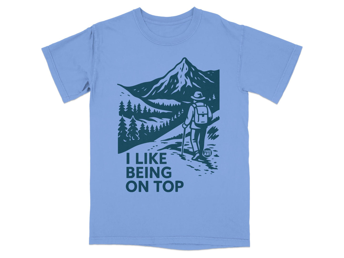T-shirt with mountains, trees, and hiker; text "I LIKE BEING ON TOP".