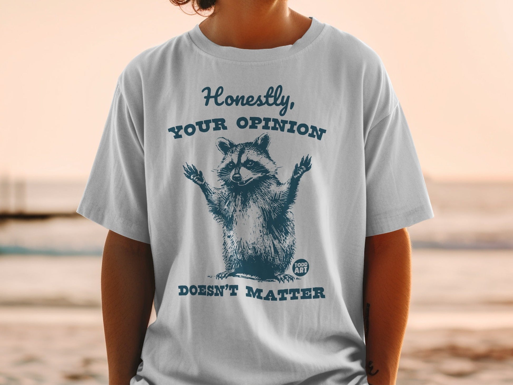 T-shirt with a raccoon graphic and the text "Honestly, Your Opinion Doesn't Matter."
