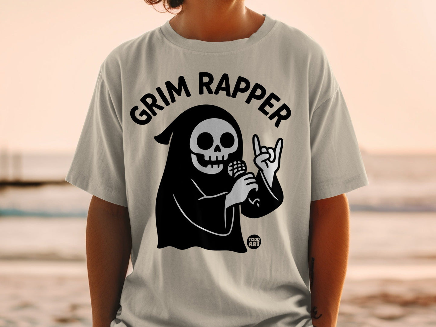 Grim Reaper graphic on a light grey t-shirt with "Grim Rapper" text.