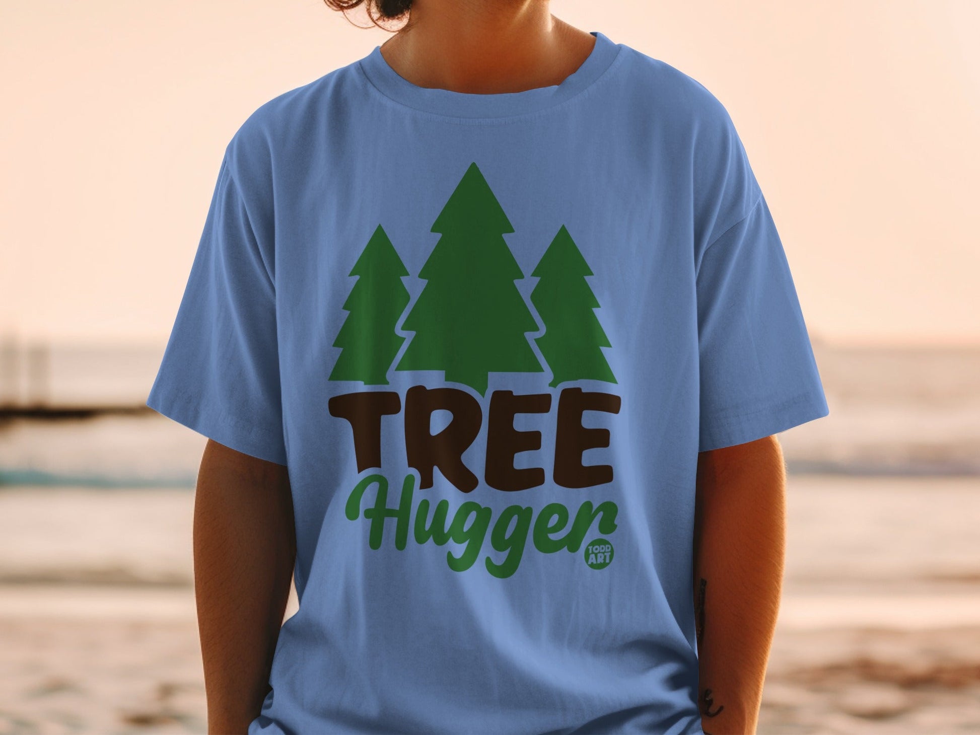 Blue t-shirt with green trees and text "TREE Hugger".
