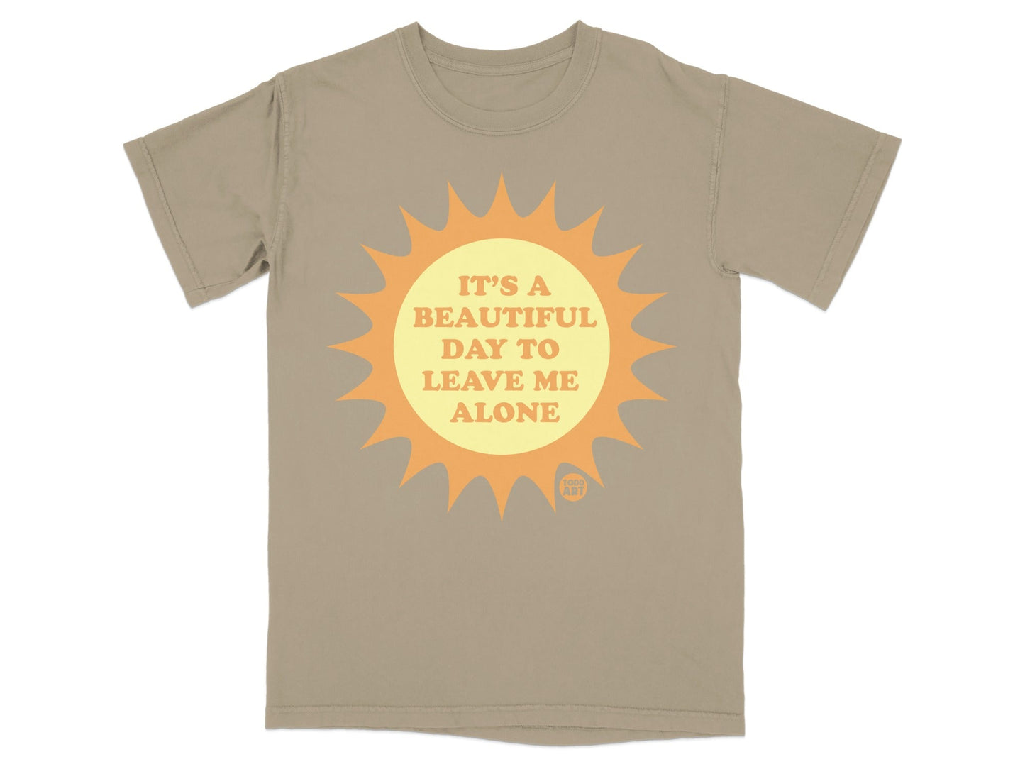 Tan t-shirt with a sun graphic and the text "IT'S A BEAUTIFUL DAY TO LEAVE ME ALONE".