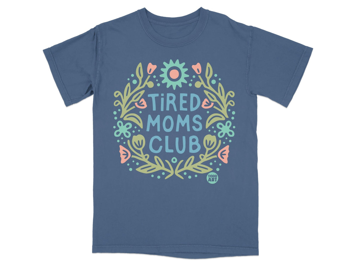 Blue t-shirt with floral wreath and "Tired Moms Club" text.