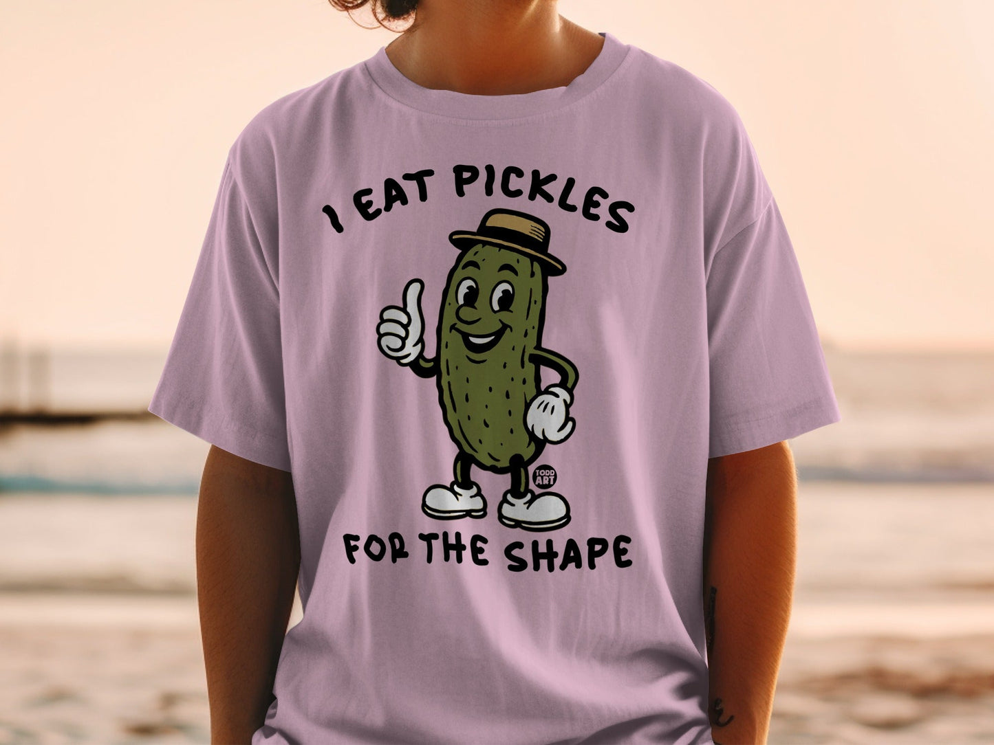 Shirt with cartoon pickle wearing a hat, giving a thumbs up.