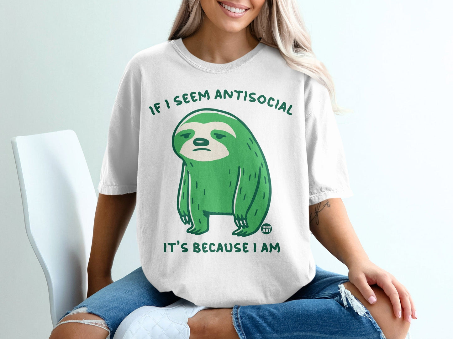 Green sloth graphic on a white t-shirt with text "If I seem antisocial it's because I am."