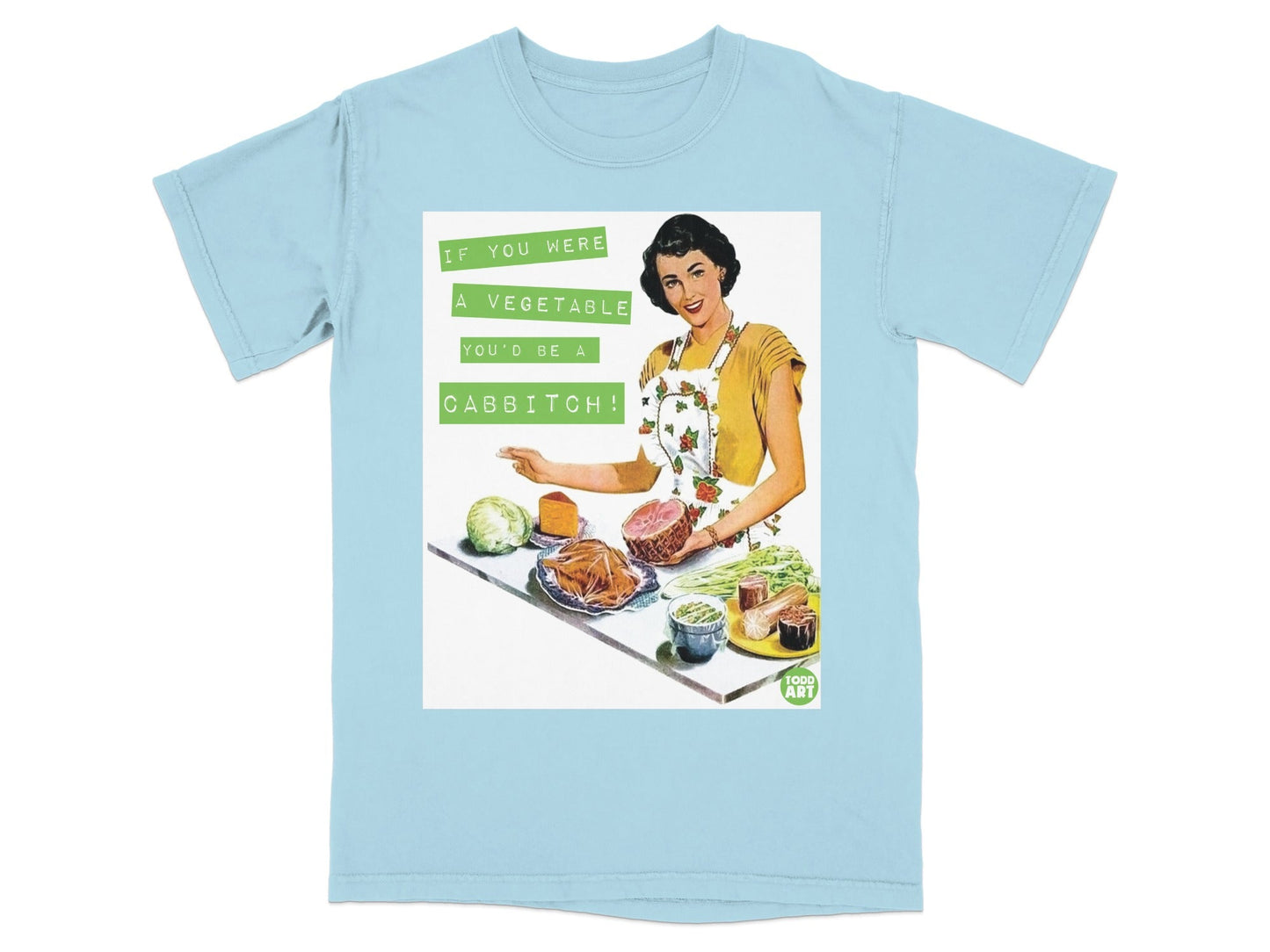 Light blue t-shirt with a graphic of a retro woman holding ham and vegetables with text.