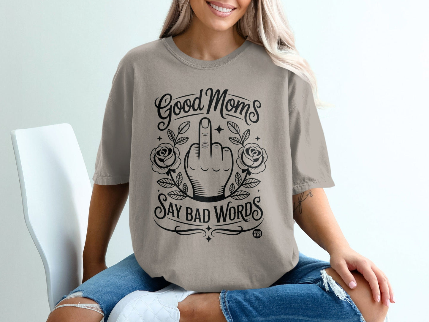 T-shirt with "Good Moms Say Bad Words" graphic featuring a hand giving the middle finger.
