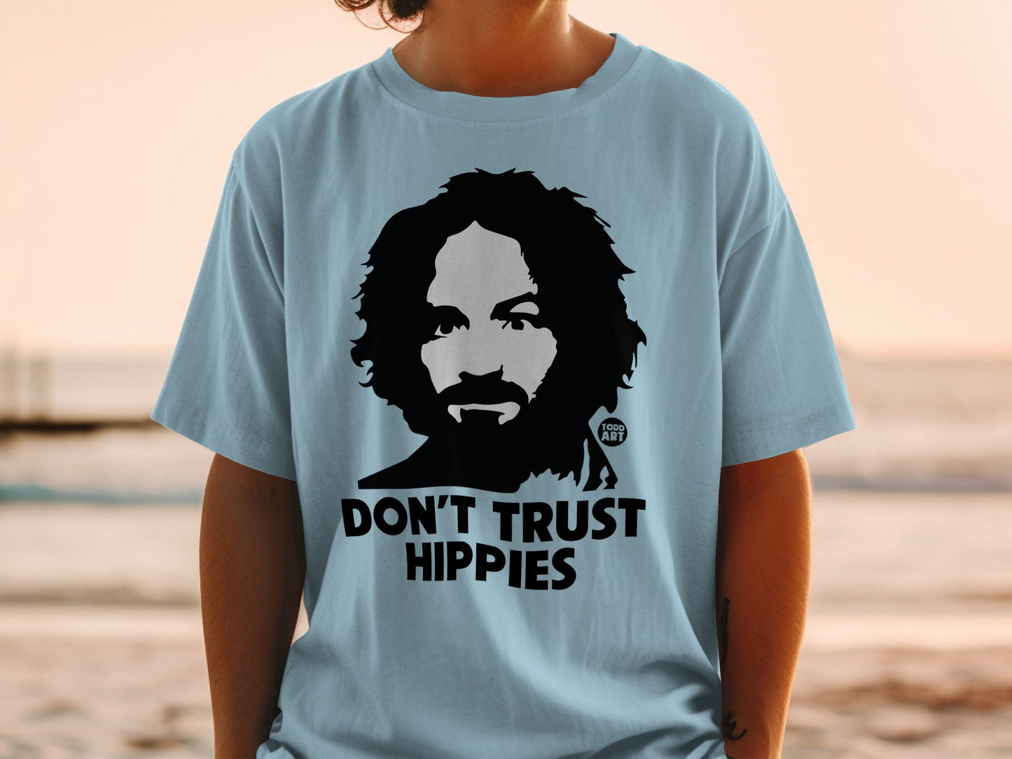 Light blue t-shirt with Charles Manson graphic and text "DON'T TRUST HIPPIES".