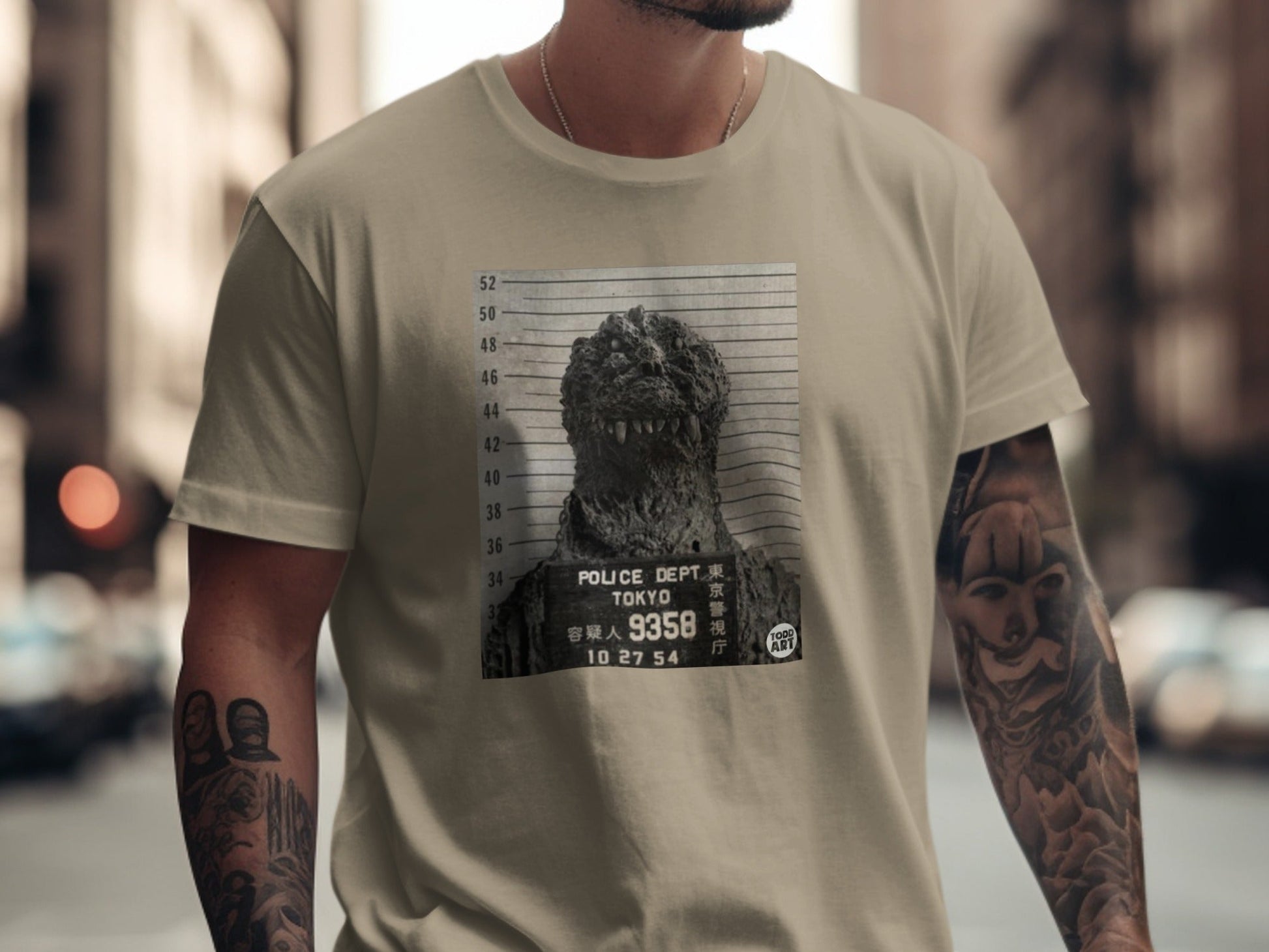 T-shirt featuring Godzilla's mugshot with Tokyo Police Dept. and case number.