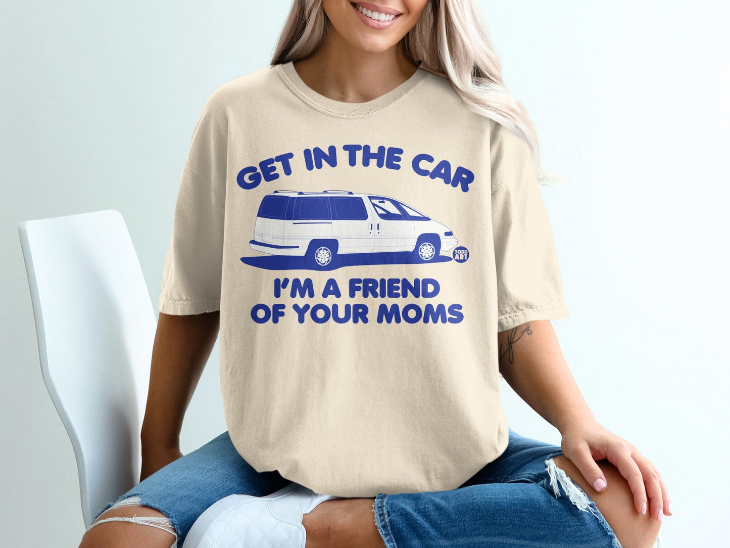 Cream t-shirt with blue text and a white minivan graphic.