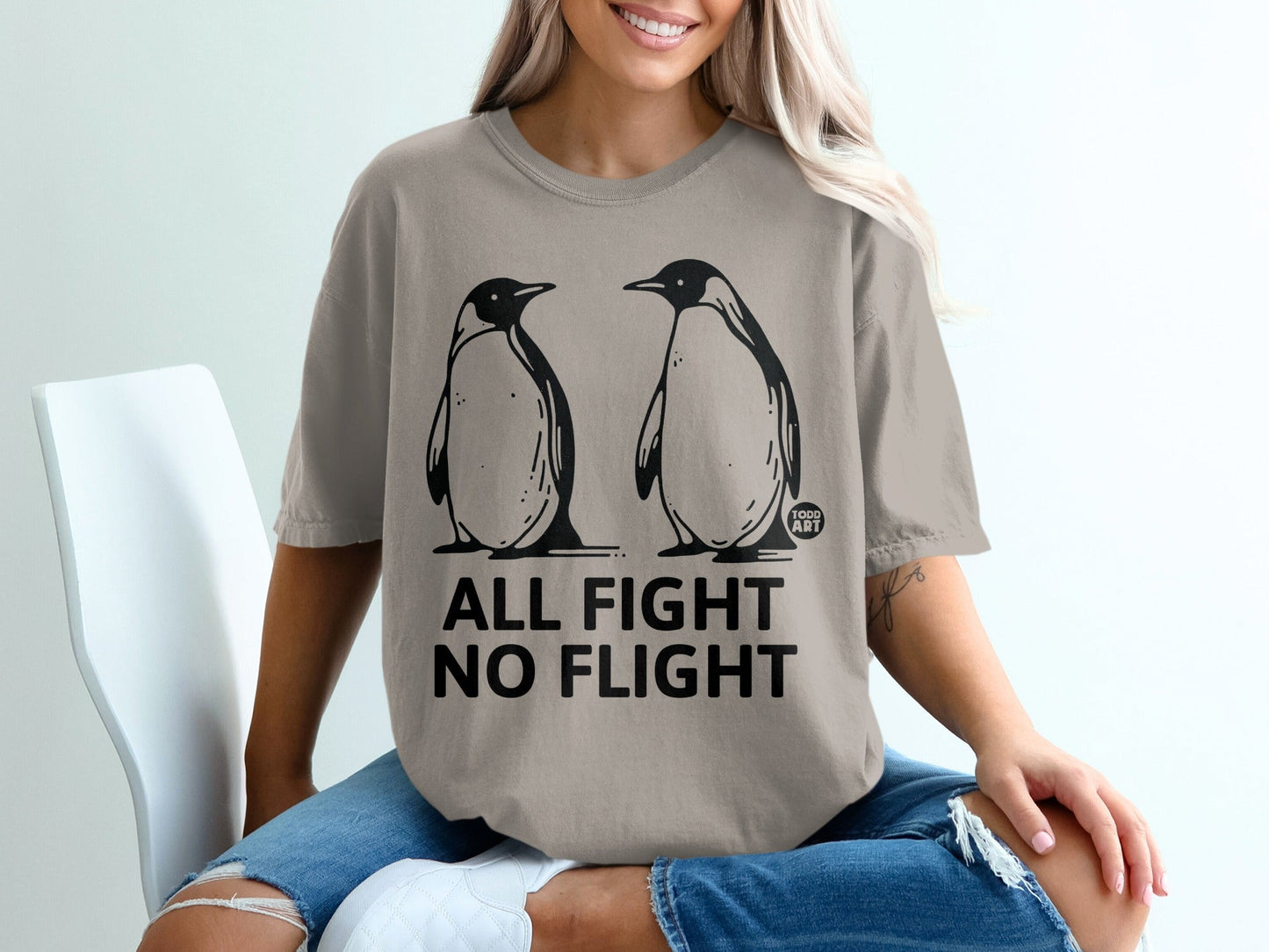 T-shirt with two penguins and "All Fight No Flight" text.