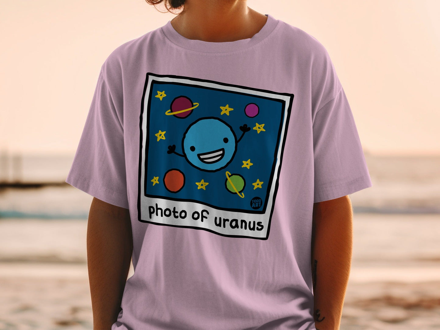 T-shirt with cartoon drawing of Uranus and stars, text reads "Photo of Uranus".