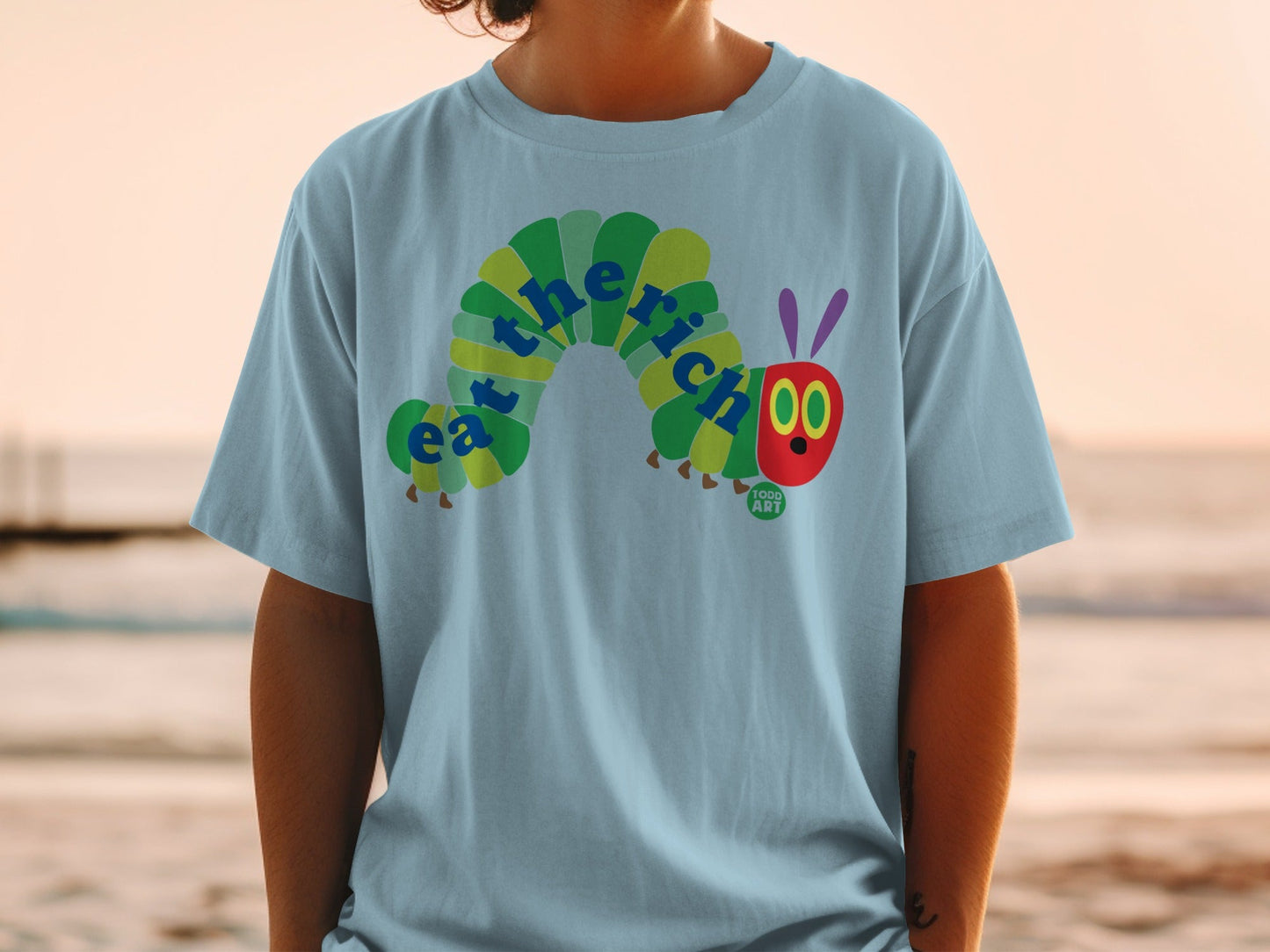 The Very Hungry Caterpillar logo is on a light blue t-shirt.