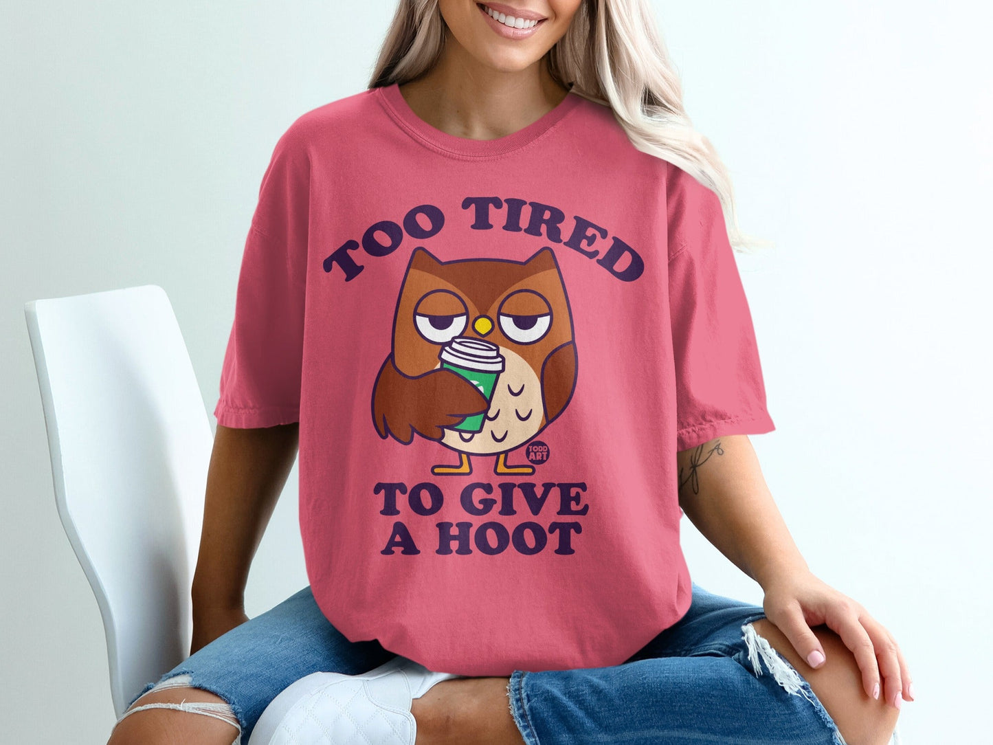 Pink t-shirt with cartoon owl holding coffee cup and text "Too tired to give a hoot".