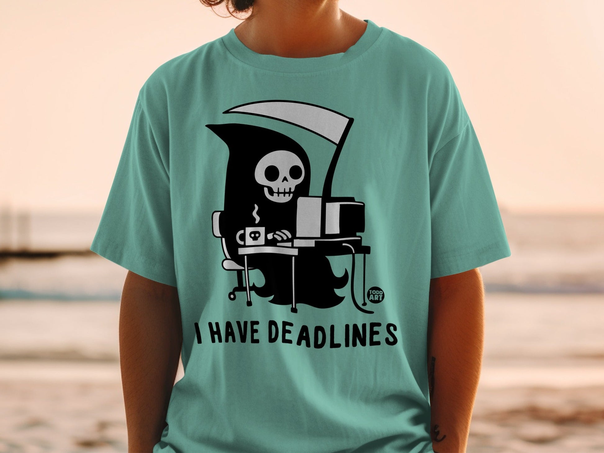 Grim reaper with a computer and coffee, "I HAVE DEADLINES" text.