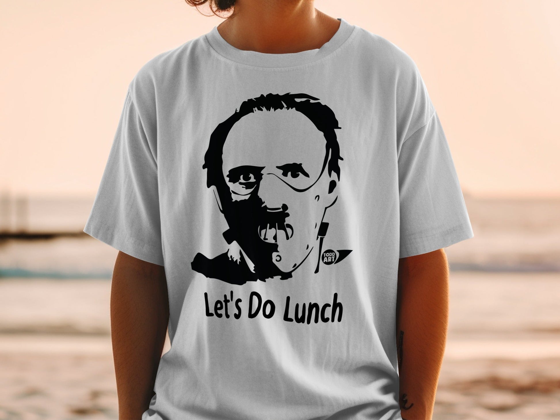 T-shirt with Hannibal Lecter mask graphic and "Let's Do Lunch" text.