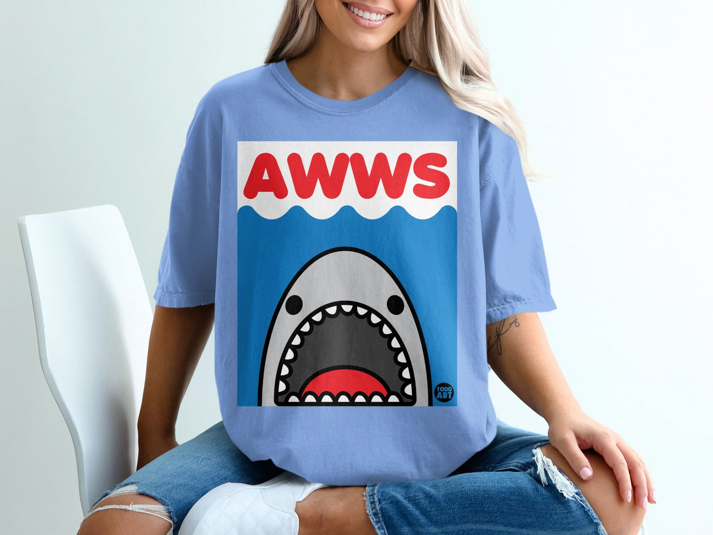 Blue t-shirt with cartoon shark and "AWWS" text.
