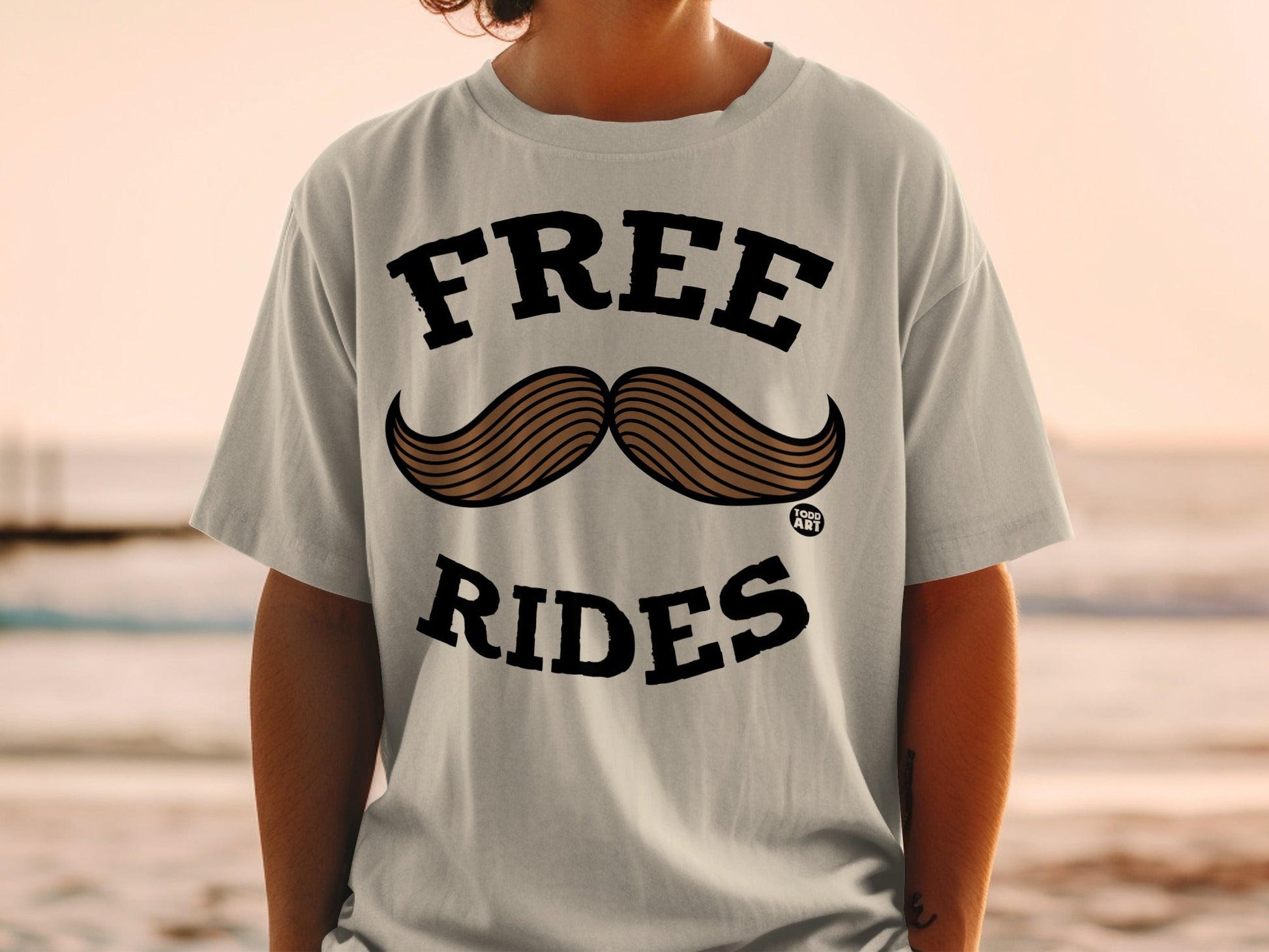 T-shirt with "FREE RIDES" text and a mustache graphic.