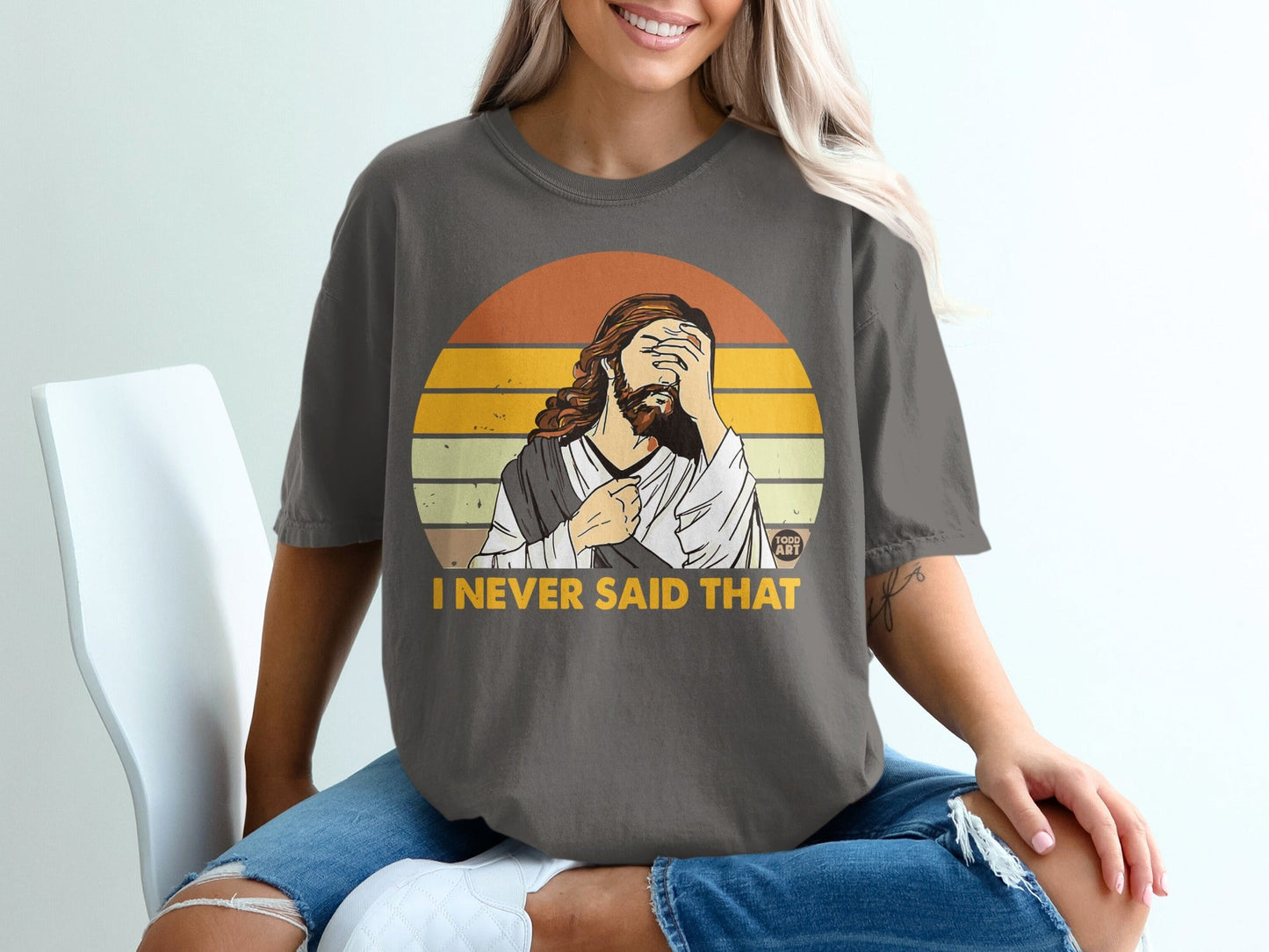 Jesus shirt with text "I NEVER SAID THAT" and a sunset graphic.