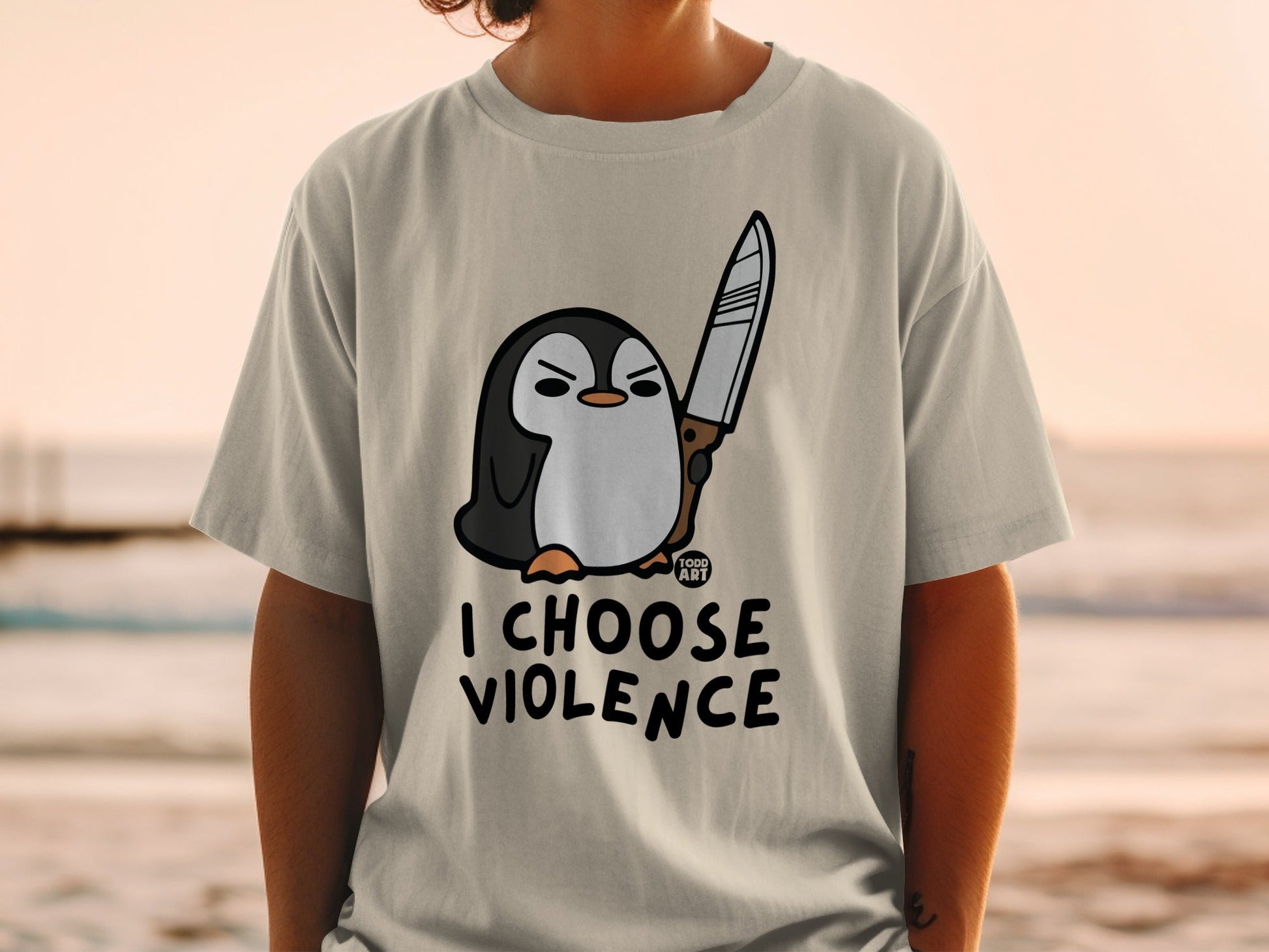 T-shirt with cartoon penguin holding a knife, text "I CHOOSE VIOLENCE".