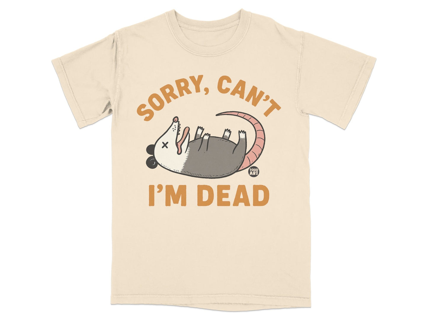 Cream t-shirt with cartoon opossum playing dead and text "SORRY, CAN'T I'M DEAD".